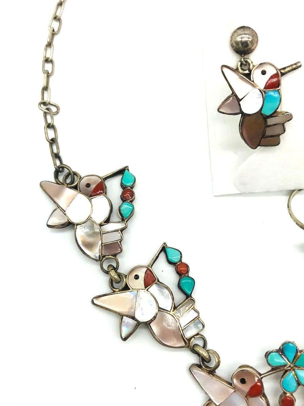 3- Piece set of Hummingbirds
Intrigue detailed birds set in carved turquoise and mother of pearl. The base is sterling silver, 925. The necklace is 18 inches in length.
Earrings are 1 inch in length and made for pierced ears.
Ring is a size 7
Total