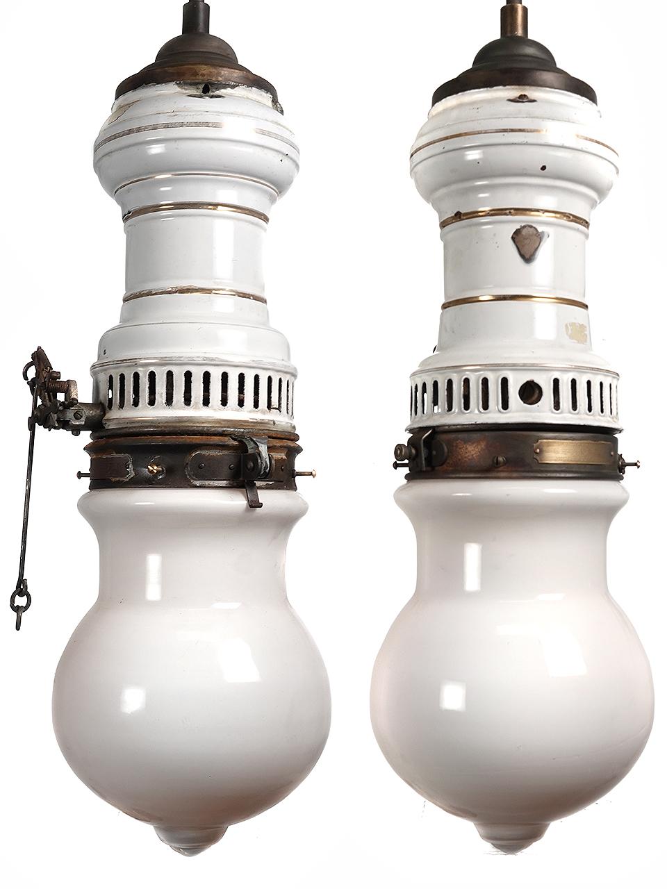 The pair of lamps are signed by the Humphrey Lamp Co. We were able to electrify the gas lamps without changing the character. Both white porcelain fixtures are of the same style with subtle differences that makes for an interesting set. The