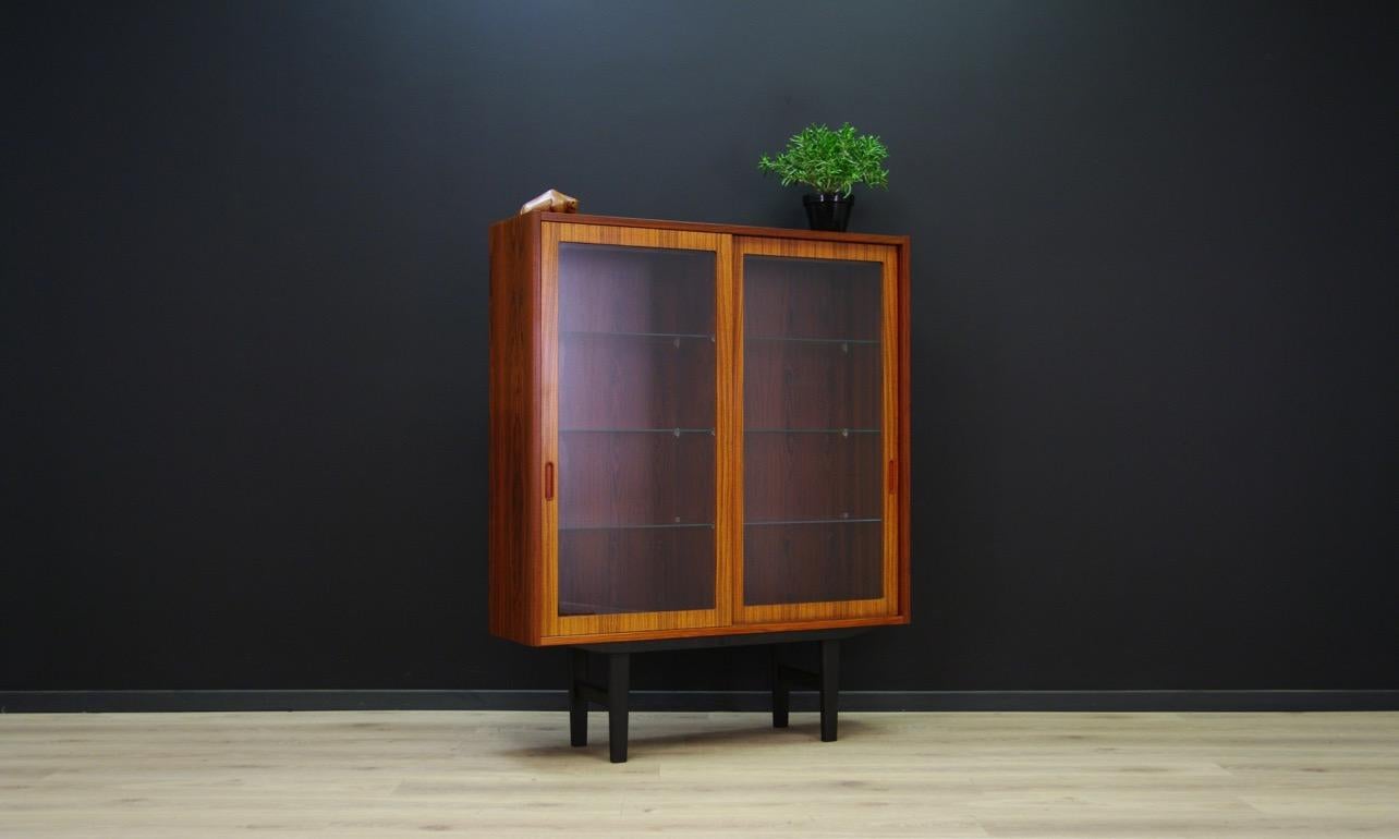 Minimalistic bookshelf from the 1960s-1970s, Danish design, phenomenal form created by Danish designer Poul Hundevad, produced in the manufacture of Hundevad & Co. The surface is veneered with rosewood. An additional advantage is the lighting,