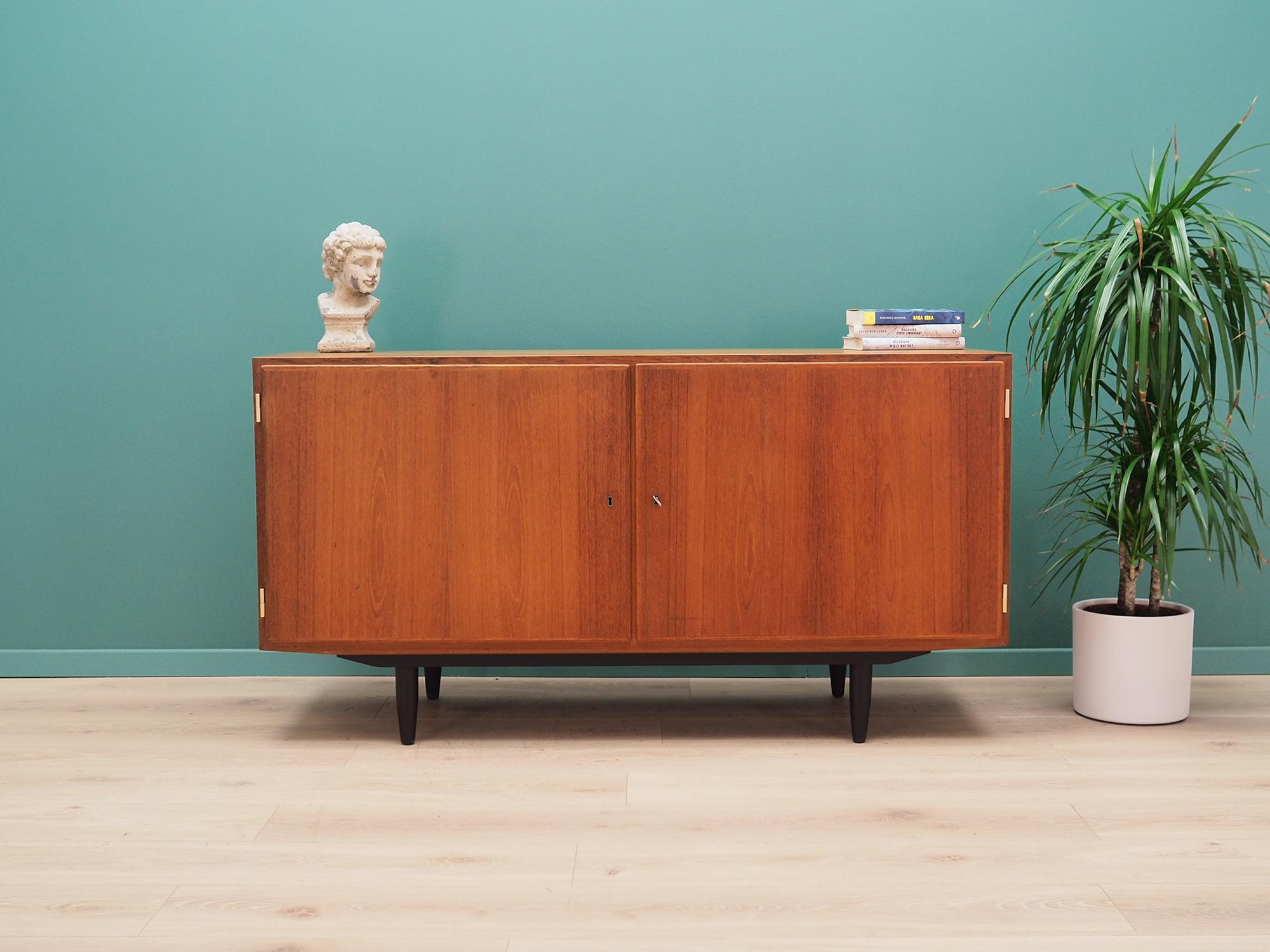 Fantastic cabinet from the 1960s-1970s. Minimalist form, Scandinavian design. The furniture is covered with teak veneer, legs are made of solid wood. Designed by Carlo Jensen, produced in the Hundevad workshop. The cabinet has three stylish drawers