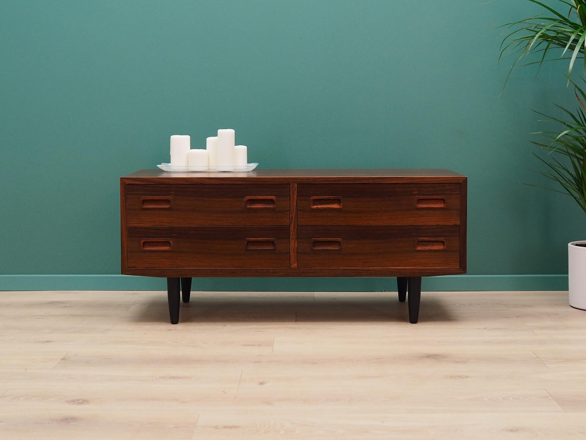 Superb chest of drawers from the 1960s-1970s. Danish design, Minimalist form. Manufactured by Hundevad & Co. Surface of the furniture finished with rosewood veneer. Furniture with four drawers. Preserved in good condition (minor bruises and