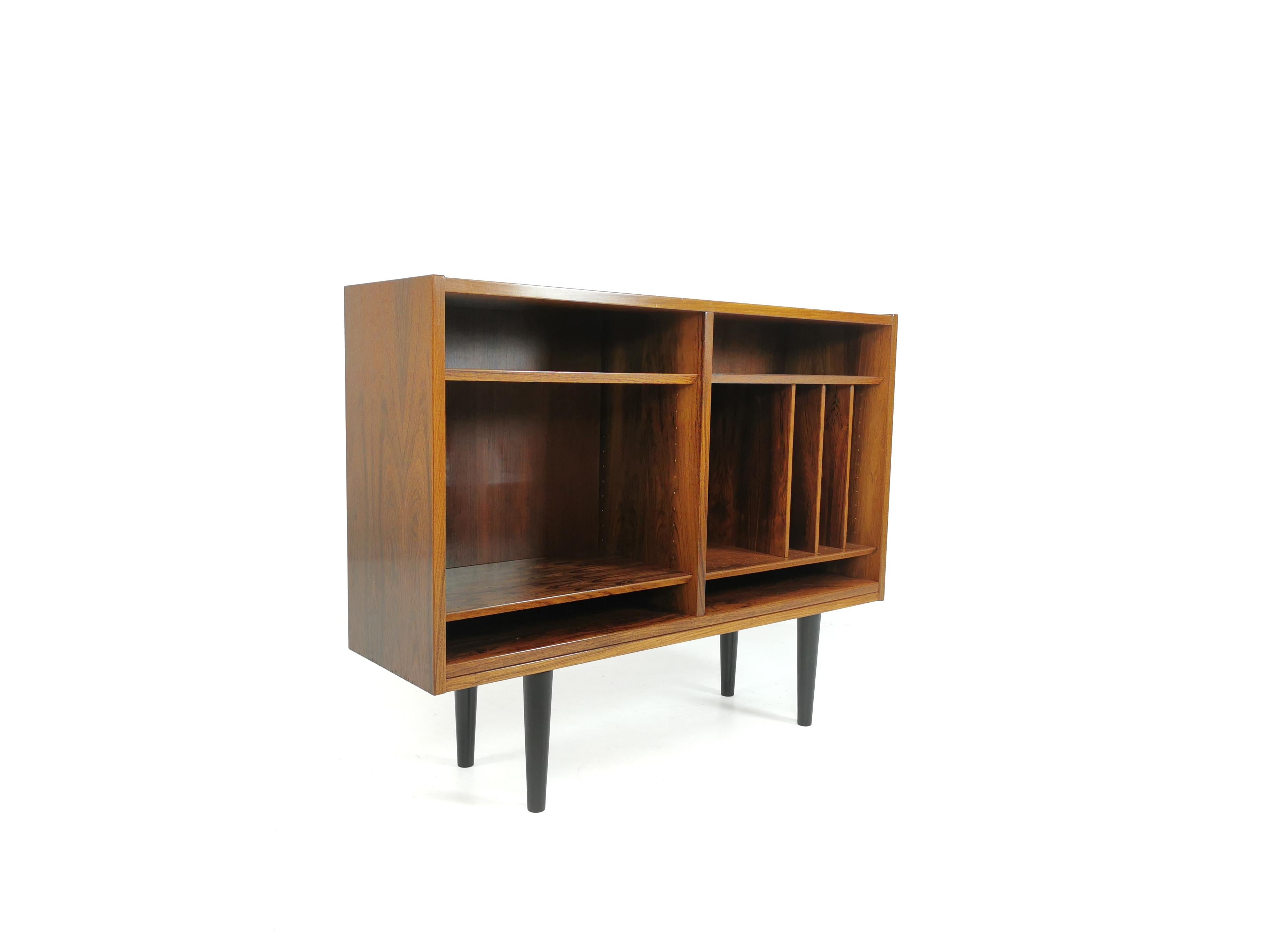Bookcase from the midcentury by Danish designer Poul Hundevad for the Hundevad & Co.

Rosewood bookcase sat on ebonized legs.