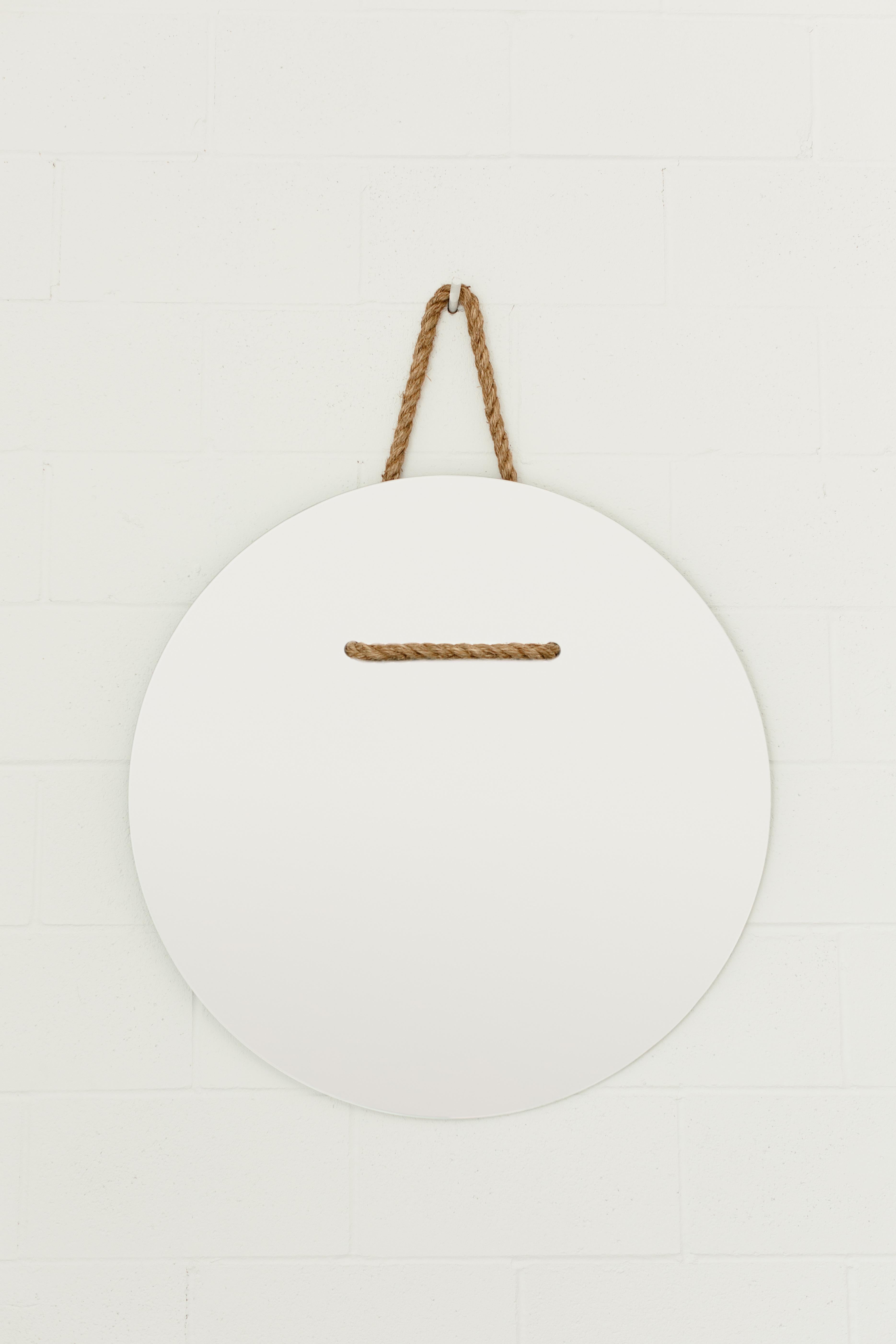 An oval shaped waterjet cut mirror threaded and hung by manila rope.

Dimensions:
Overall Height: 42 in / 106.7 cm
Width: 32 in / 81.3 cm
Depth: 0.25 in / 0.6 cm
Rope Dia: 0.75 / 1.9 cm

Custom sizes/shapes available. 

Material:
Mirrored clear