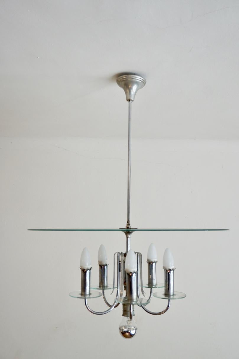 Hungarian Art Deco Bauhaus style round chrome-glass chandelier from 1930s

This chandelier is a perfect example of the mutation of design styles during the 1930s. The light fixture conceived as a modernist reference to the traditional multi-candle