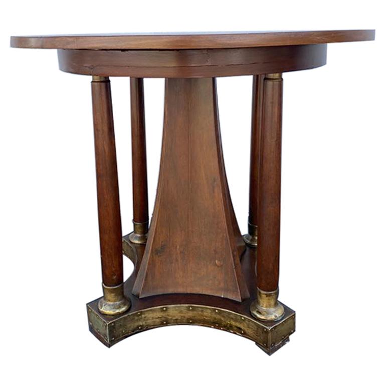 Walnut table 1930s period with the brass buts and the finished with the brass skirt. Table top intarziato (inlaid woodwork).