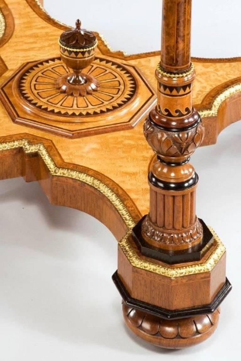 This exhibition quality table is attributed to Holland and Sons. The octagonal top is supported by four turned knopped legs, all joint by a solid shaped stretcher centred on an urn. The whole piece is decorated with the most exquisite marquetry in