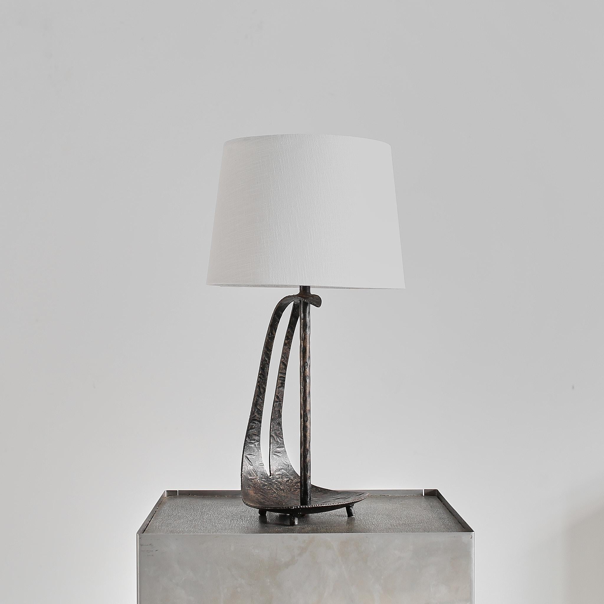 A Hungarian blackened tooled steel brutalist table lamp from Budapest.

Unusual curved design.

Recently professionally re-wired/PAT tested.

Measurements include lampshade.

Price includes re-wiring for USA/Europe.