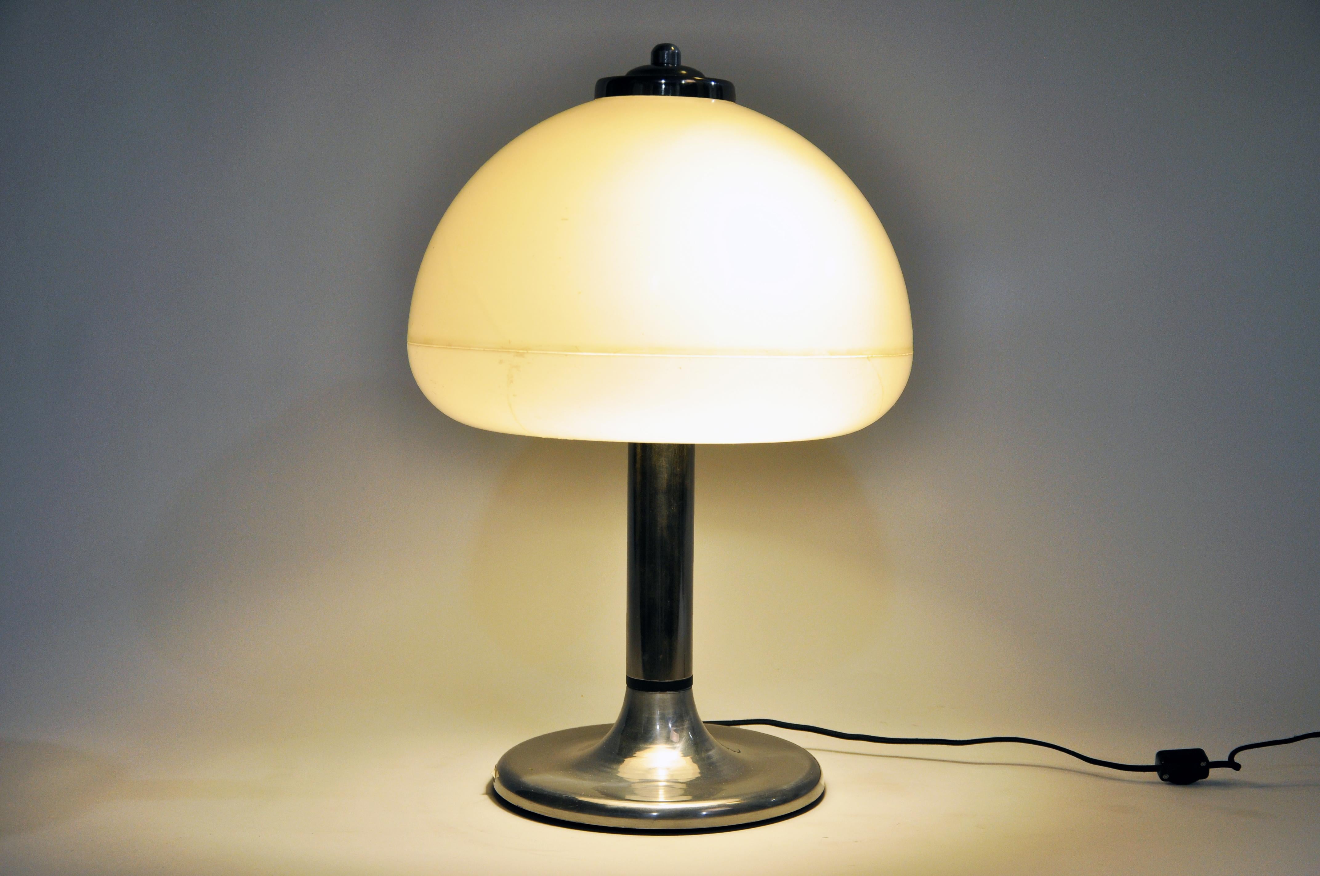 Mushroom-shaped table lamp with opaque shades and nickel base; from Hungary and made from metal and resin, circa 1950. Wear consistent with age and use.
     