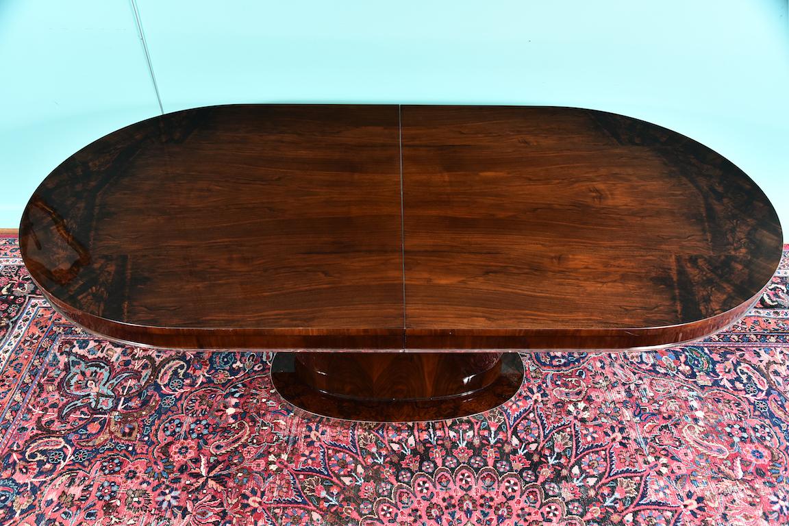 Hungarian dining room table in walnut, Art Deco period
Great Art Deco table made out of fine walnut wood. It has oval tabletop with chrome trimming on the edge. Tabletop has one insert.
Top is supported by the oval elongated leg and a base. Base of