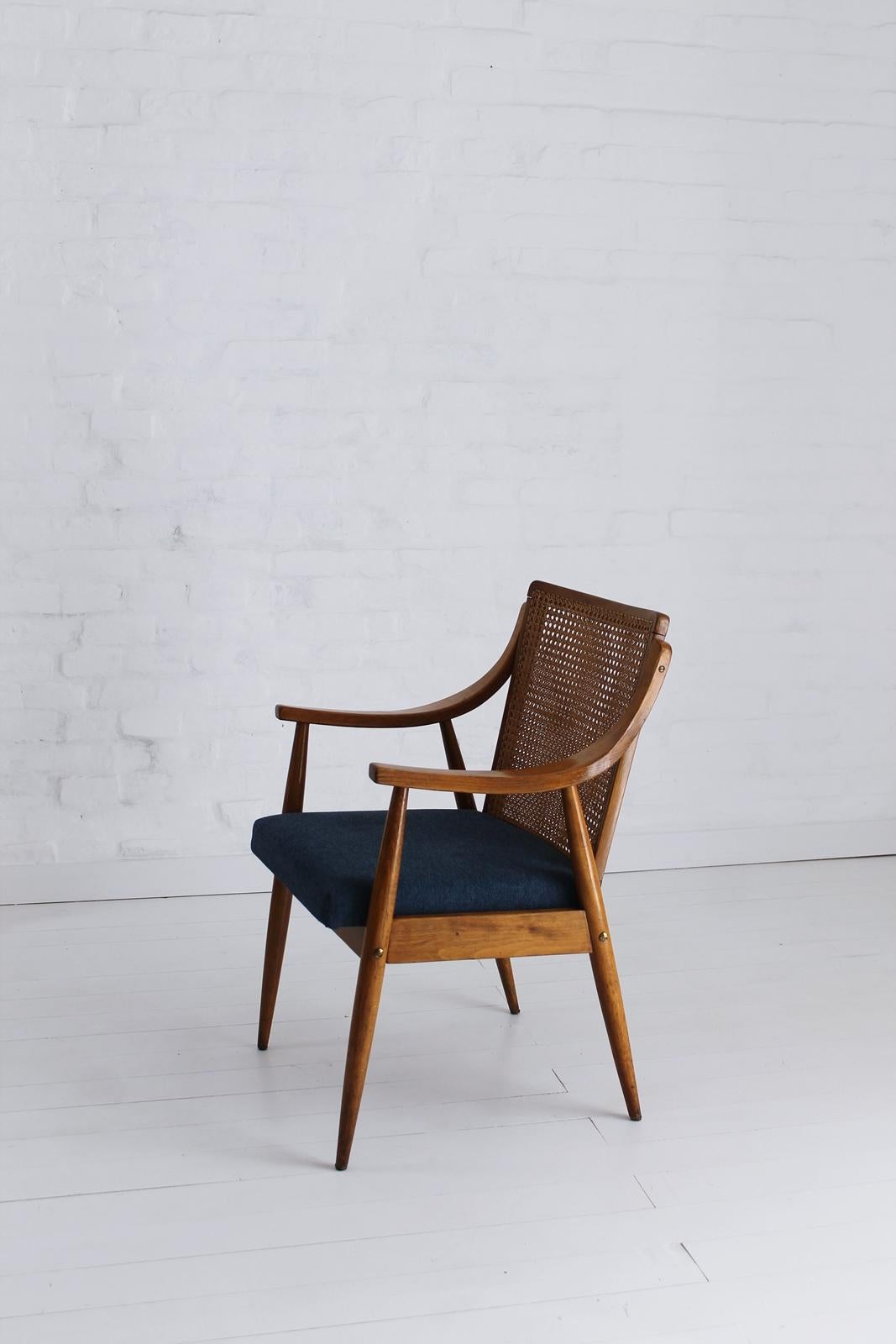 Rare Mid-Century Modern Hungarian armchair in style of Peter Hvidt and Orla Mølgaard-Nielsen, in very good condition.
This chair in beechwood with caned back is newly upholstered with a denim blue fabric.