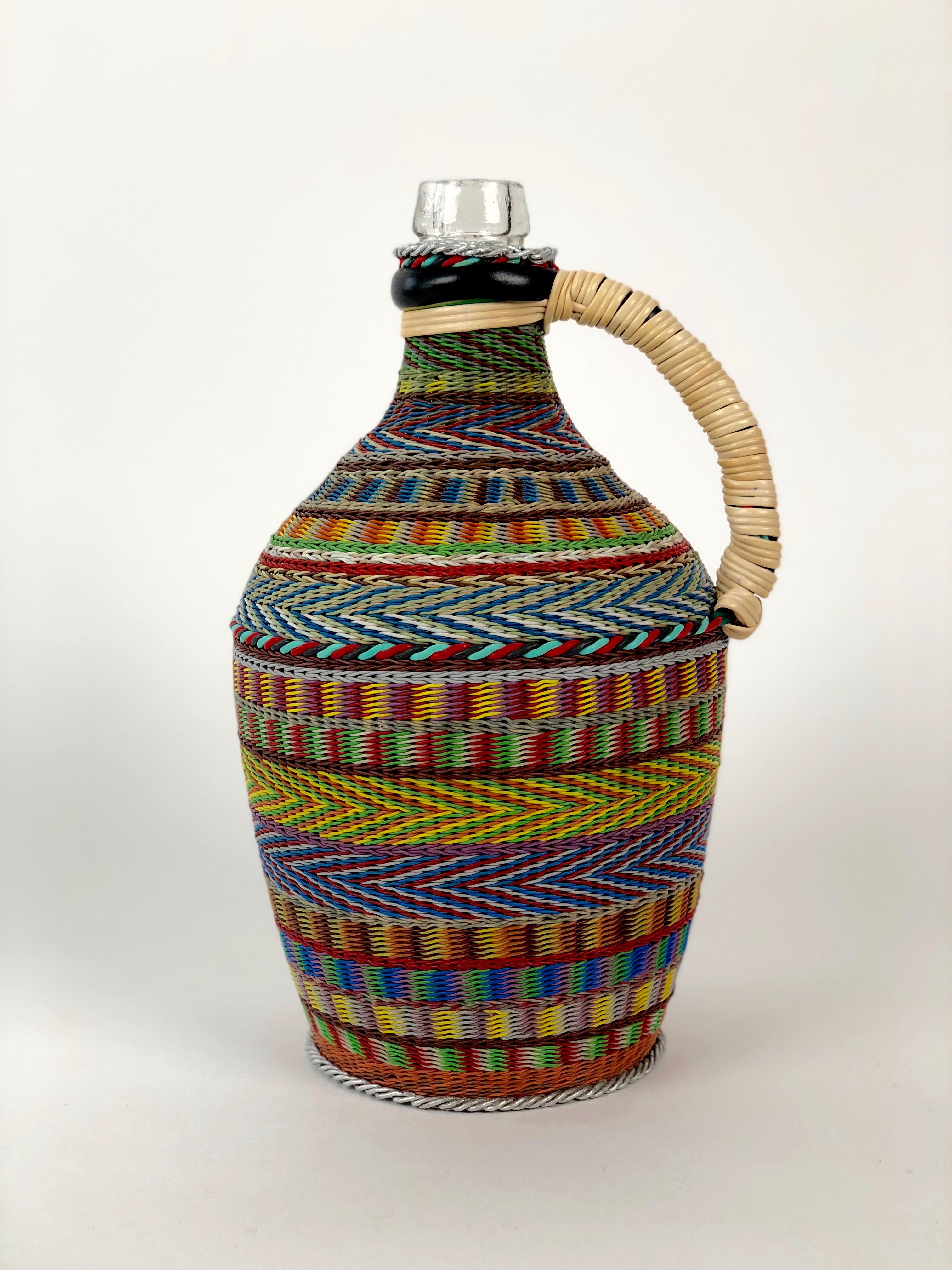 Vintage woven wire decorated wine bottle. The pattern and technique are based on traditional basket 
weaving. The results after many hours of work, is a unique piece of Folk Art. The woven wire bottle 
was made in Hungary in the 1960's .

Today,