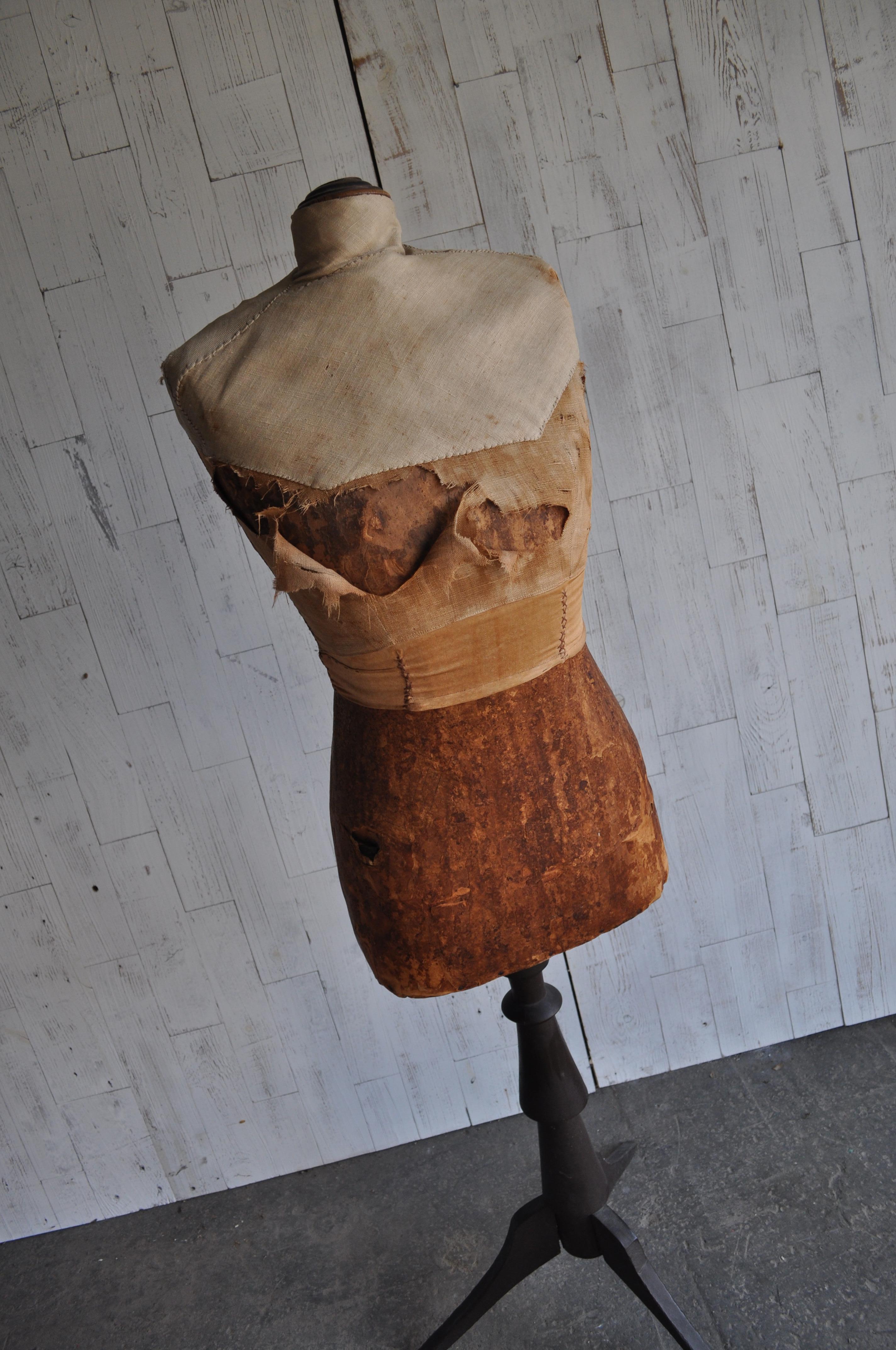 A handsome antique dress form from Hungary. All original with linen bodice and base. Original painted base is a dark brown.
Very good, patina, tears to fabric, stains.