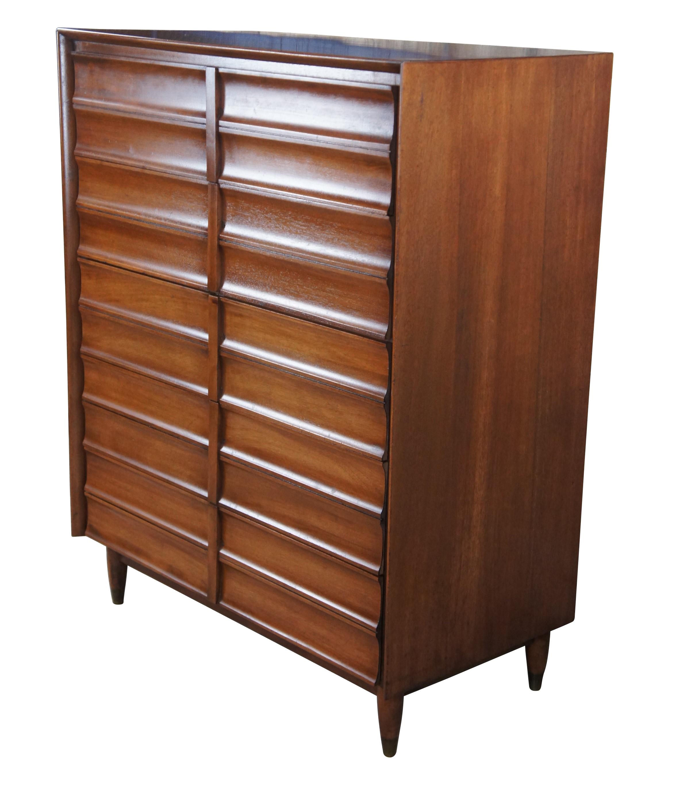 Mid Century Modern Hungerford of Memphis dresser or tall chest of drawers.  Made of mahogany featuring five drawers and brass capped feet.  8706 Five Drawer Chest, Royal Pastel.

Hungerford Furniture was known for choosing Elvis to be the focus