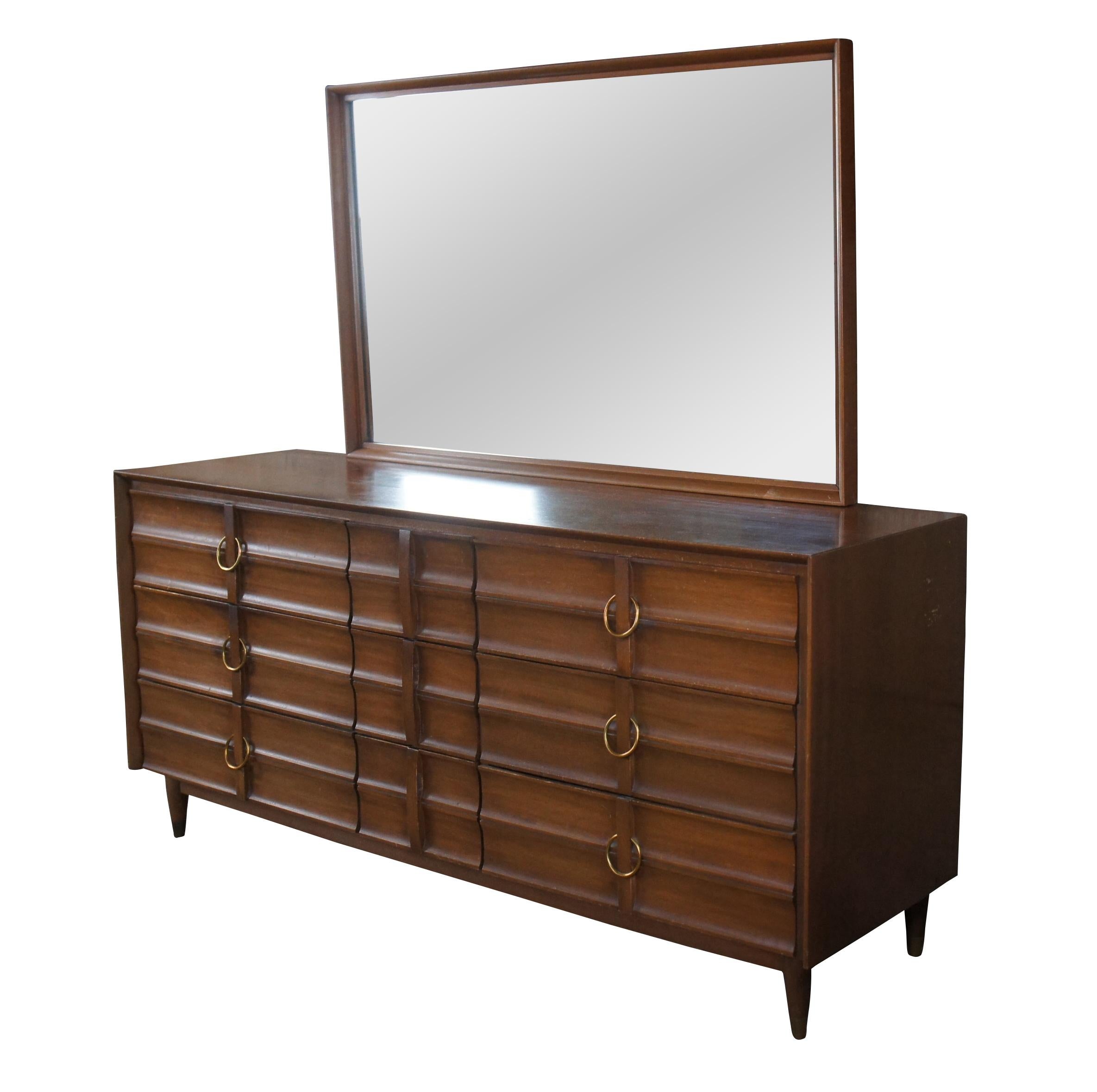 Mid Century Modern Hungerford of Memphis dresser or chest of drawers with vanity mirror.  Made of mahogany featuring nine drawers with brass hardware, capped feet and rectangular mirror.

Hungerford Furniture was known for choosing Elvis to be the
