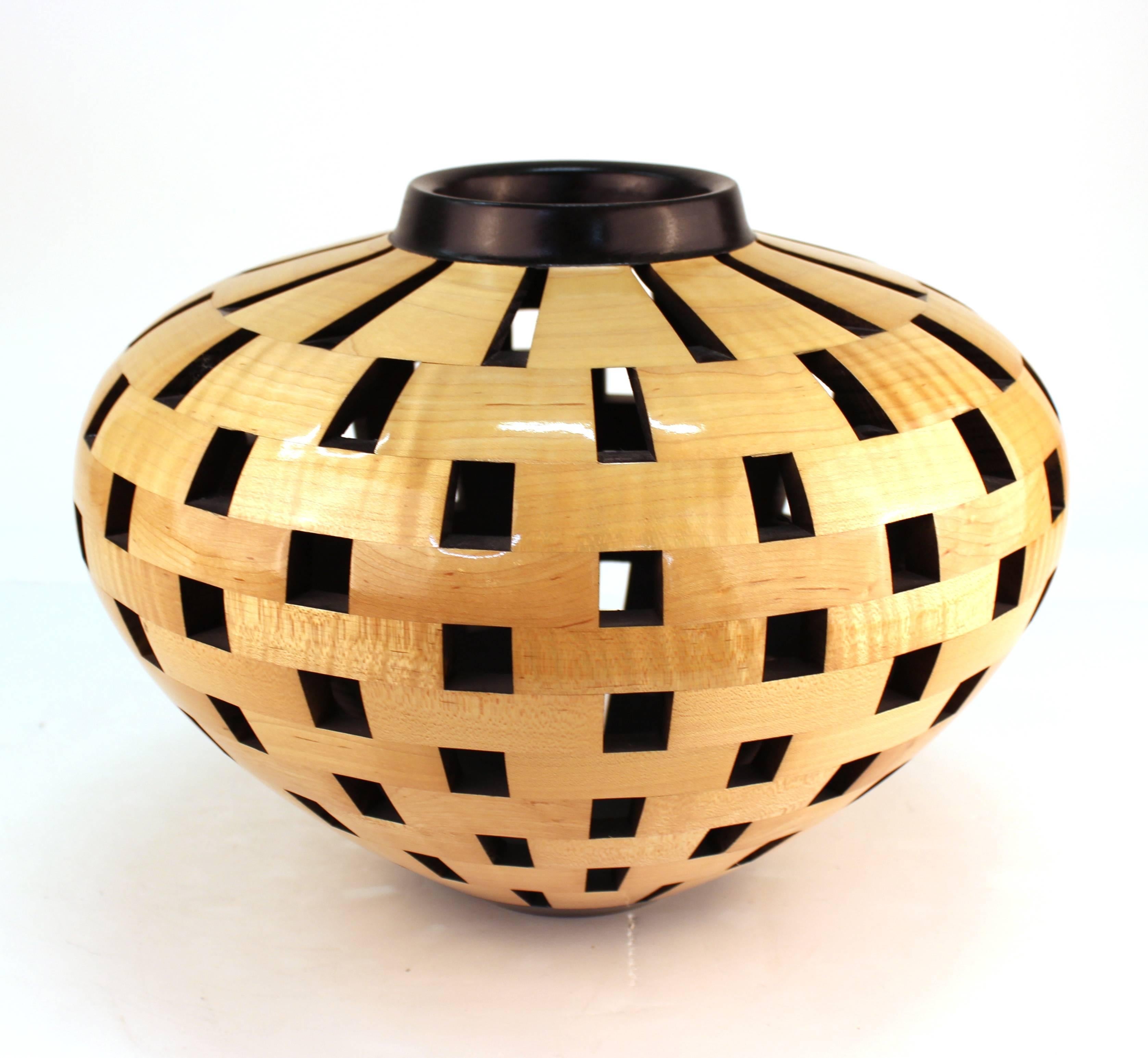 A segmented wooden lacquered vessel, made by Joel Hunnicutt. The piece is signed on the bottom and is in great condition.