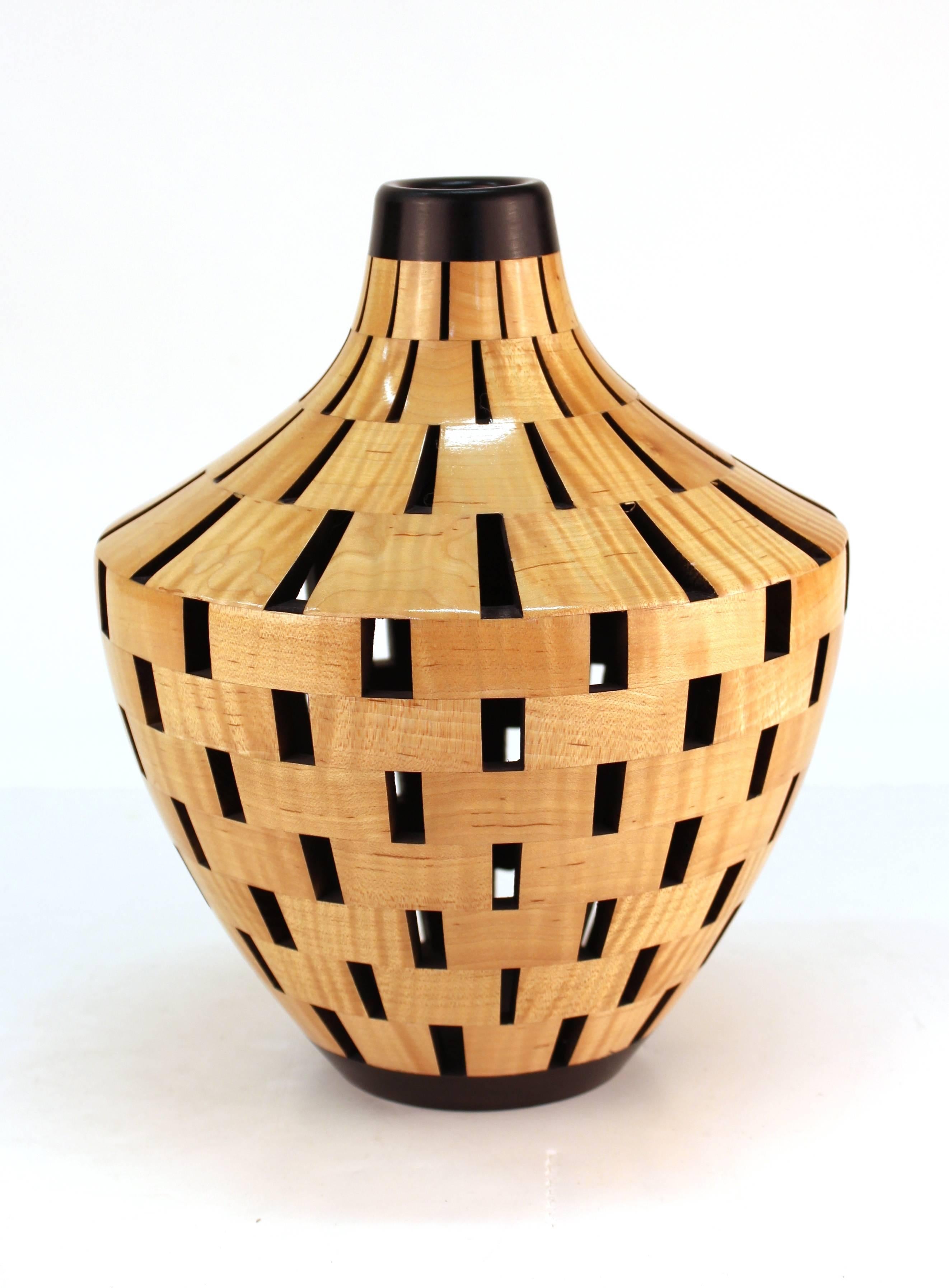 A segmented wooden lacquered vessel made by Joel Hunnicutt. The piece is indicative of Hunnicutt's artistic style and is in great condition. Signed on the bottom.