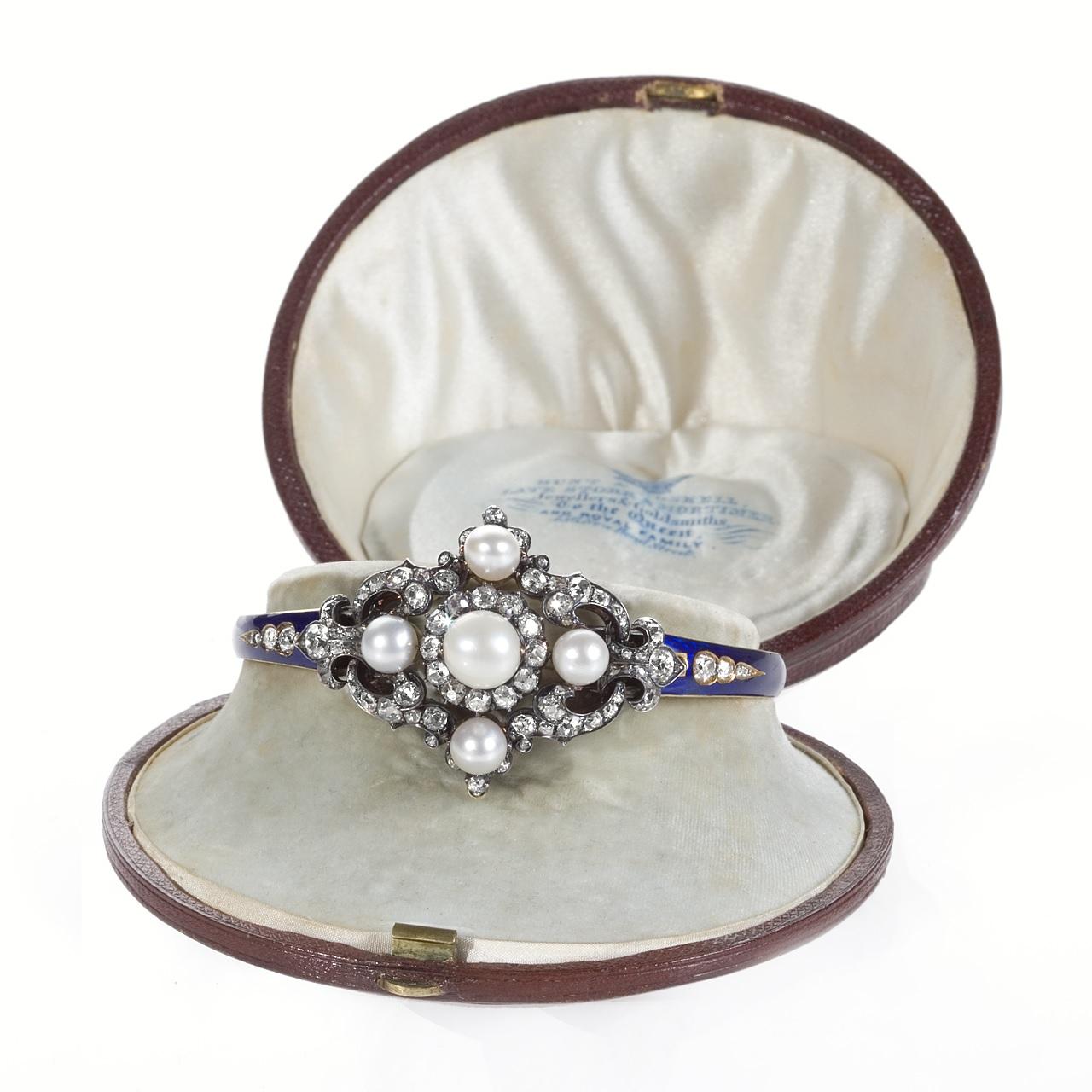 An Antique English 18 karat gold, diamond, natural pearl and enamel hinged bracelet by Hunt & Roskell of London.  The bracelet features 84 old mine- and rose-cut diamonds that have the approximate total weight of 2.70 carats. The natural pearl