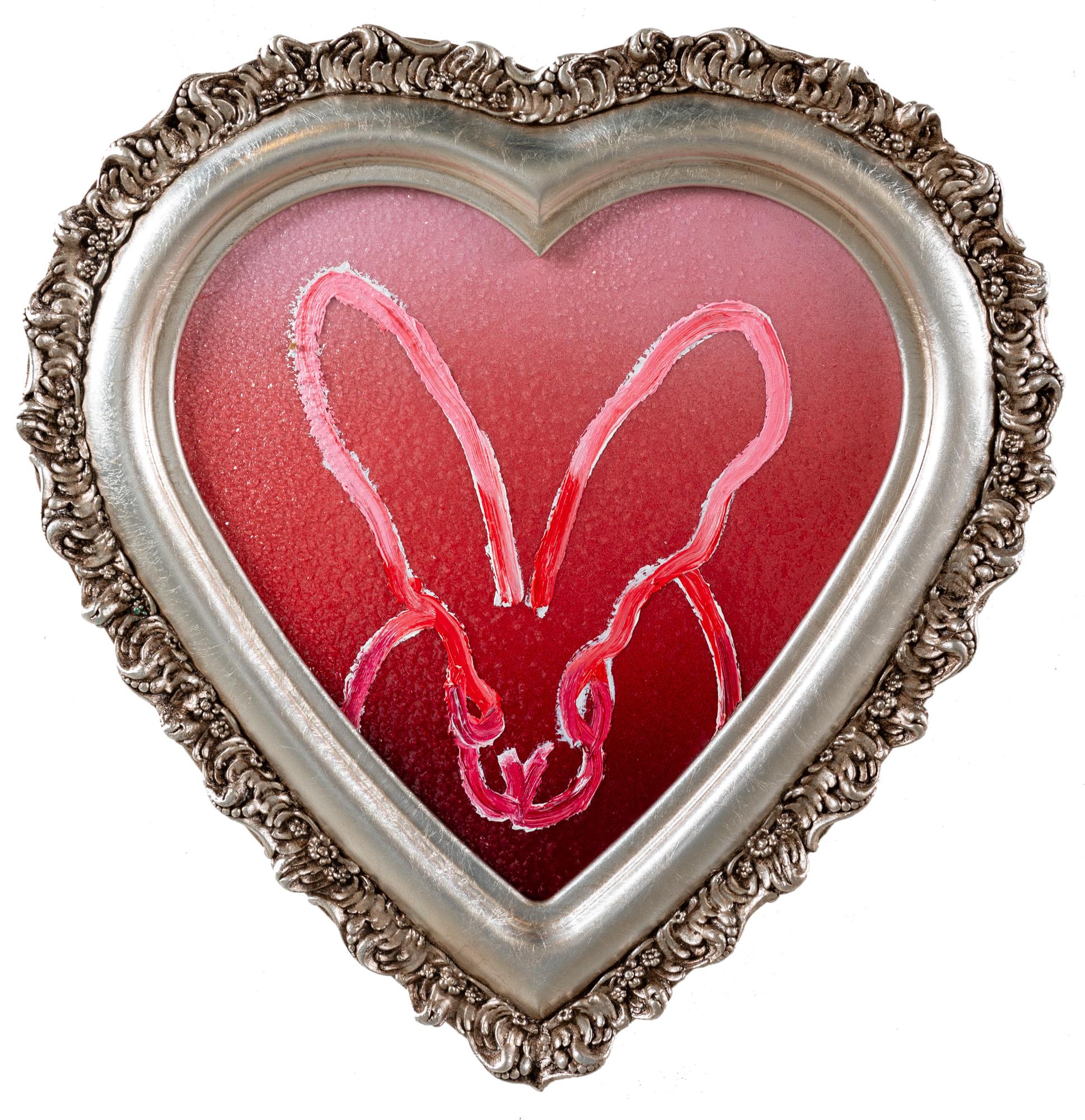 "Savannah" is a framed acrylic and oil painting on wood by Hunt Slonem, depicting a bunny atop an ombre Diamond Dust background. 

This piece is finished in an antique heart-shaped frame, which has been hand-selected by the artist for this painting.