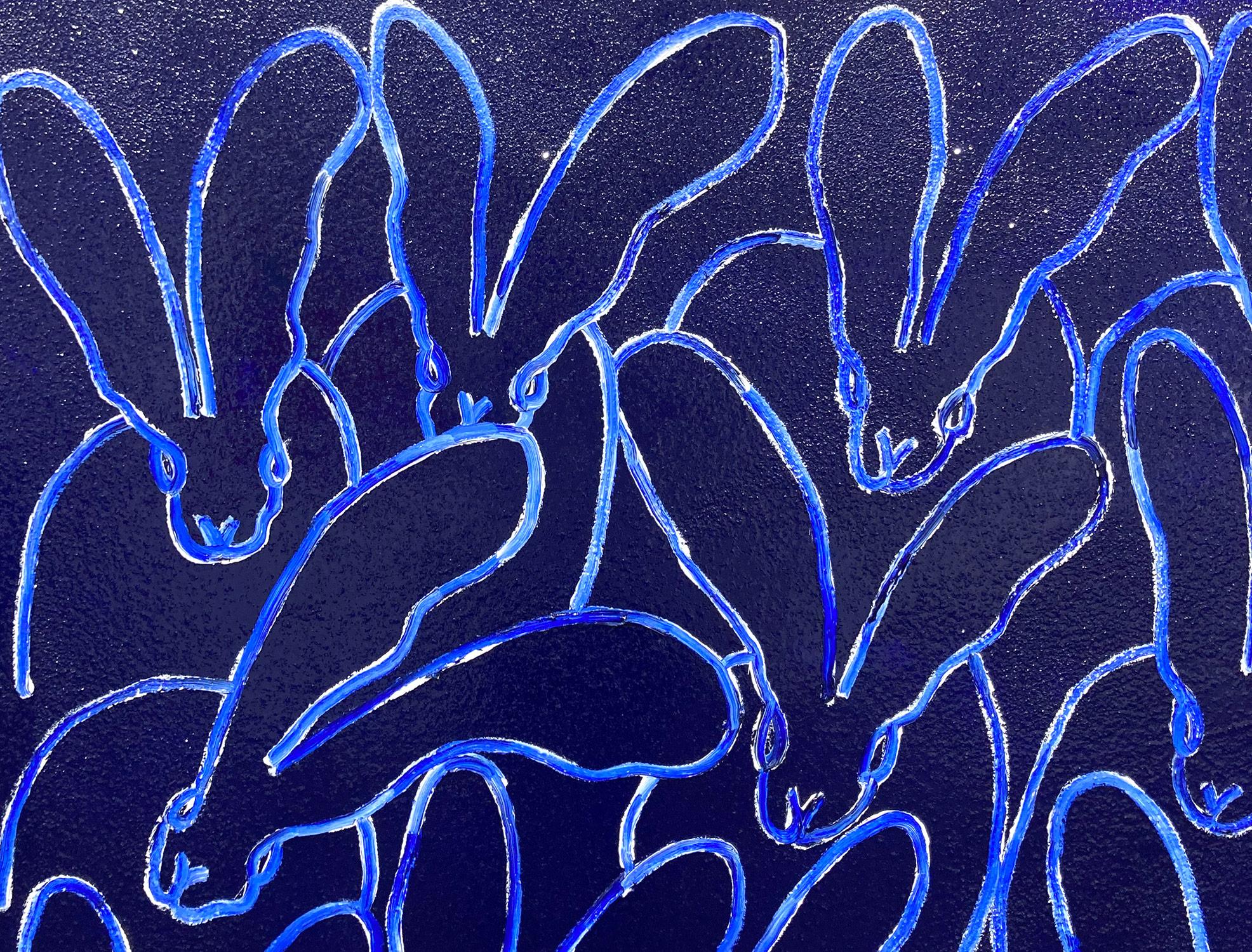 A stunning composition of one of Slonem's most iconic subjects, Bunnies. This piece depicts gestural figures of Bunnies against an ultramarine blue diamond dust background. Slonem traces these bunnies with thick white paint and then encases the