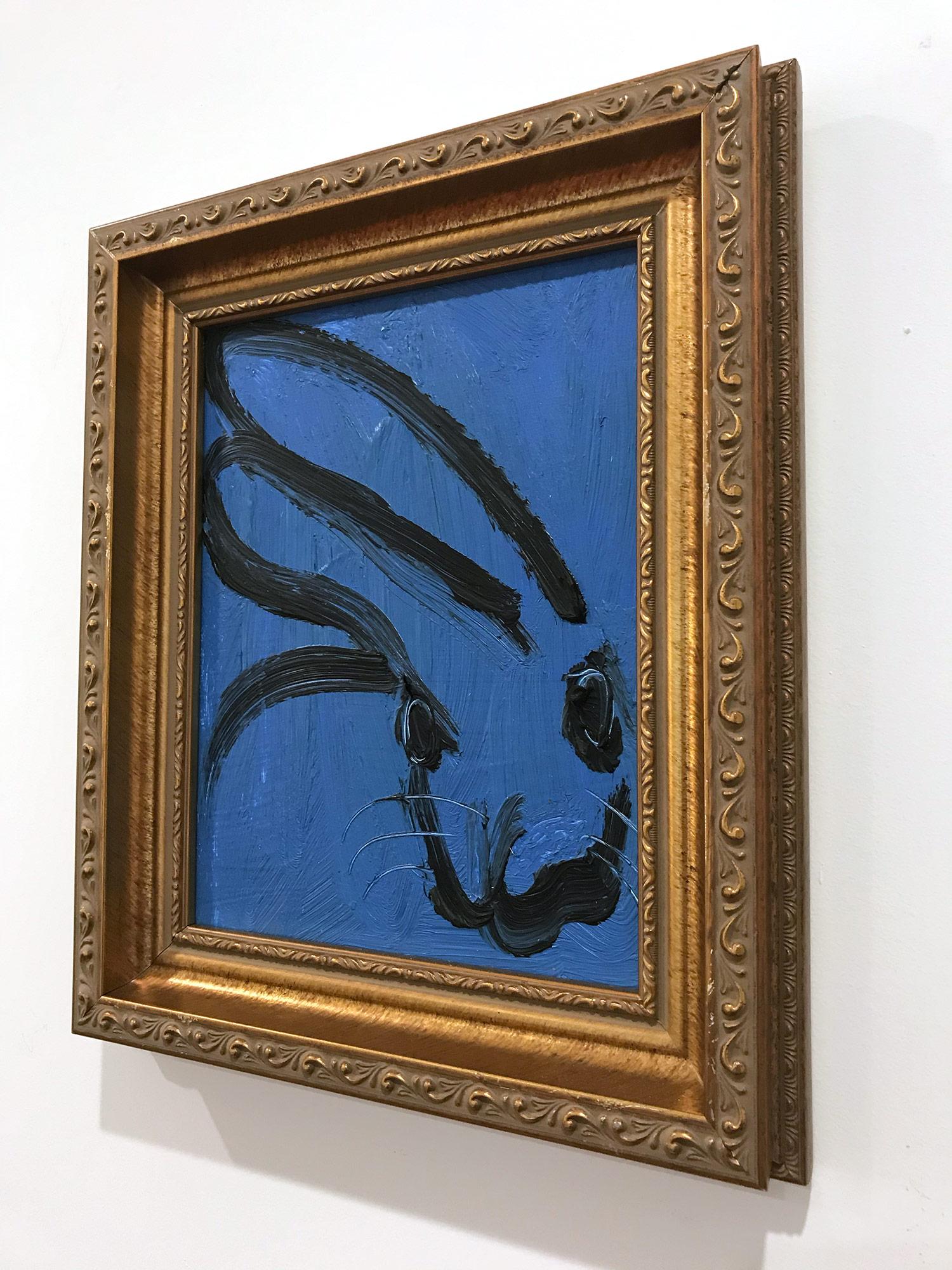 A wonderful composition of one of Slonem's most iconic subjects, Bunnies. This piece depicts a gestural figure of a black bunny on a Royal blue background with thick use of paint. It is housed in a wonderful antique style carved wood frame. Inspired