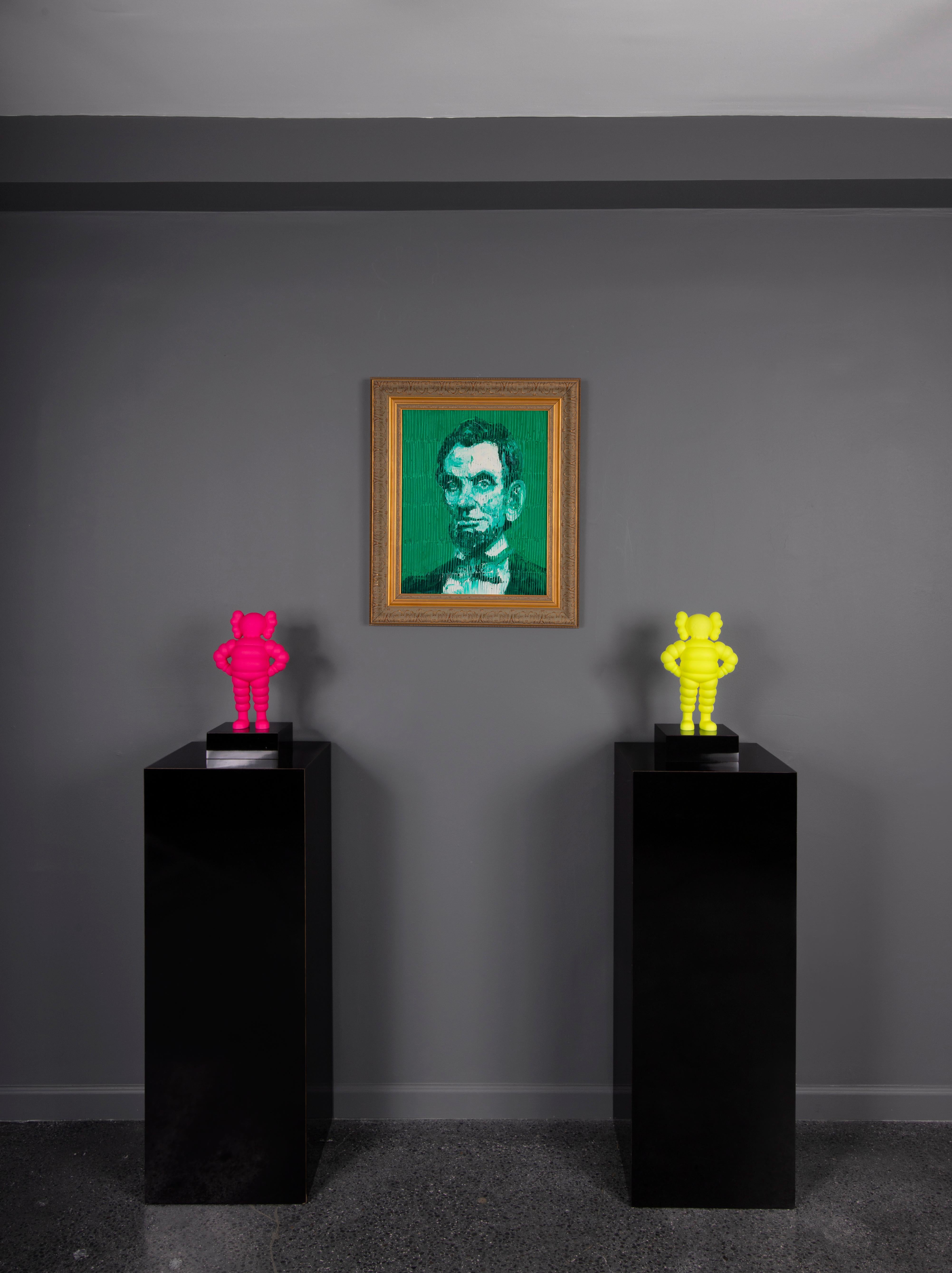 ‘Green Abraham Lincoln’ is a framed monochrome portrait of Abraham Lincoln. Slonem paints Lincoln in vibrant and thick green oil paint. He then goes back to the portrait with the end of his paintbrush, creating a geometric grid-like pattern that