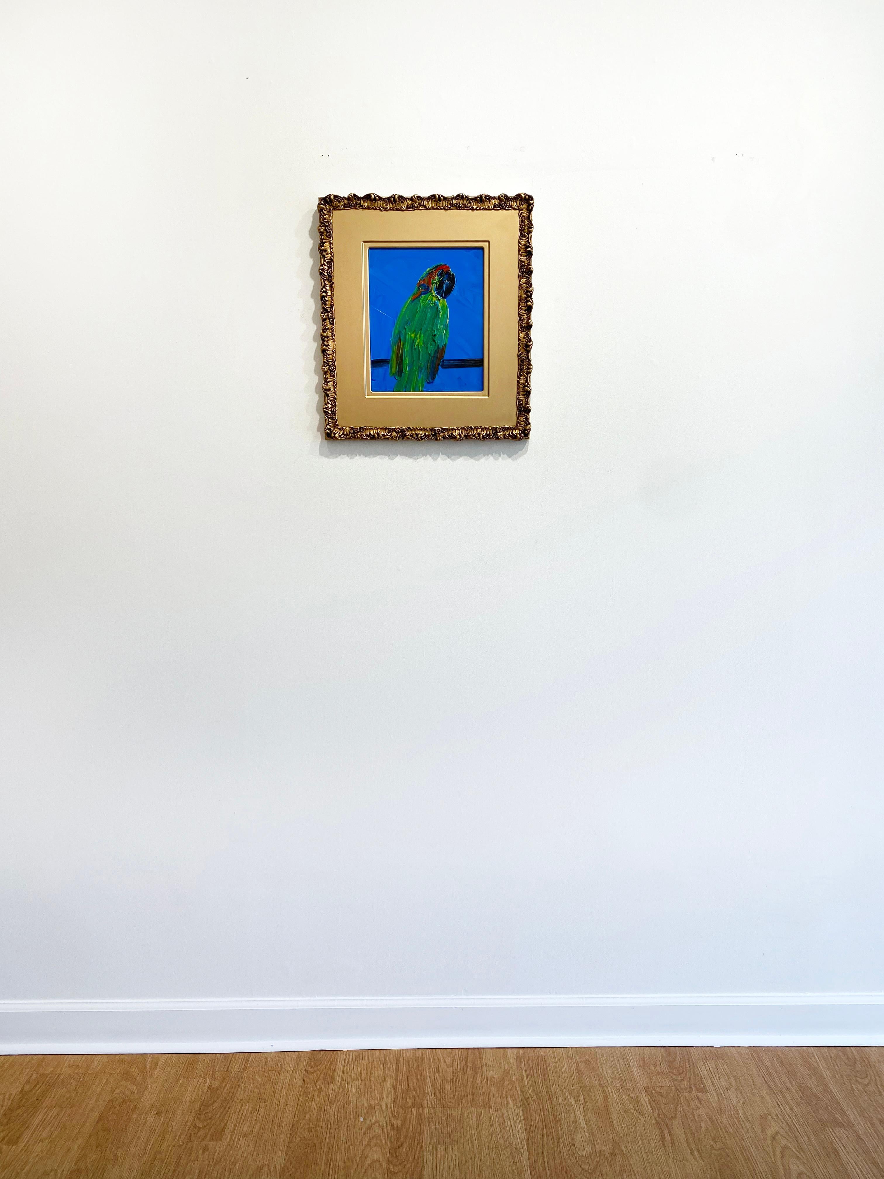 'Great Blue' by Hunt Slonem, 2021. Oil on wood, 12 x 10 in. Framed size is 20 x 18 in. This painting features a charming and striking portrait of a parrot. The parrot is lavishly painted in bright shades of green, yellow, and red, on a bright blue