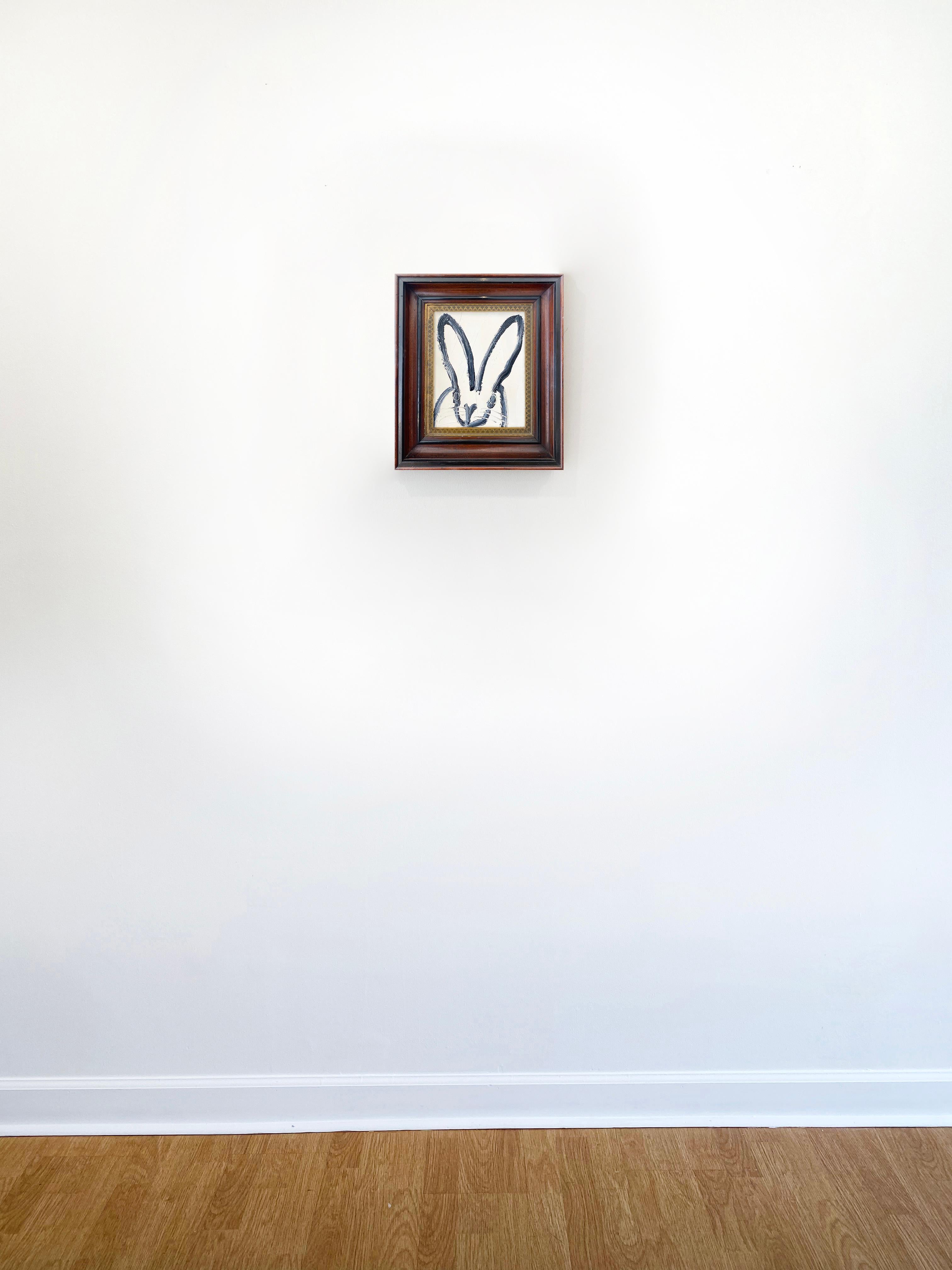 'Barbara' by Hunt Slonem, 2021. Oil on wood, 10 x 8 in. Framed size is 15 x 13 in. This painting features Slonem's signature bunny outlined in black on a bright white background.  This charming bunny features slender ears, and an expressive face. 
