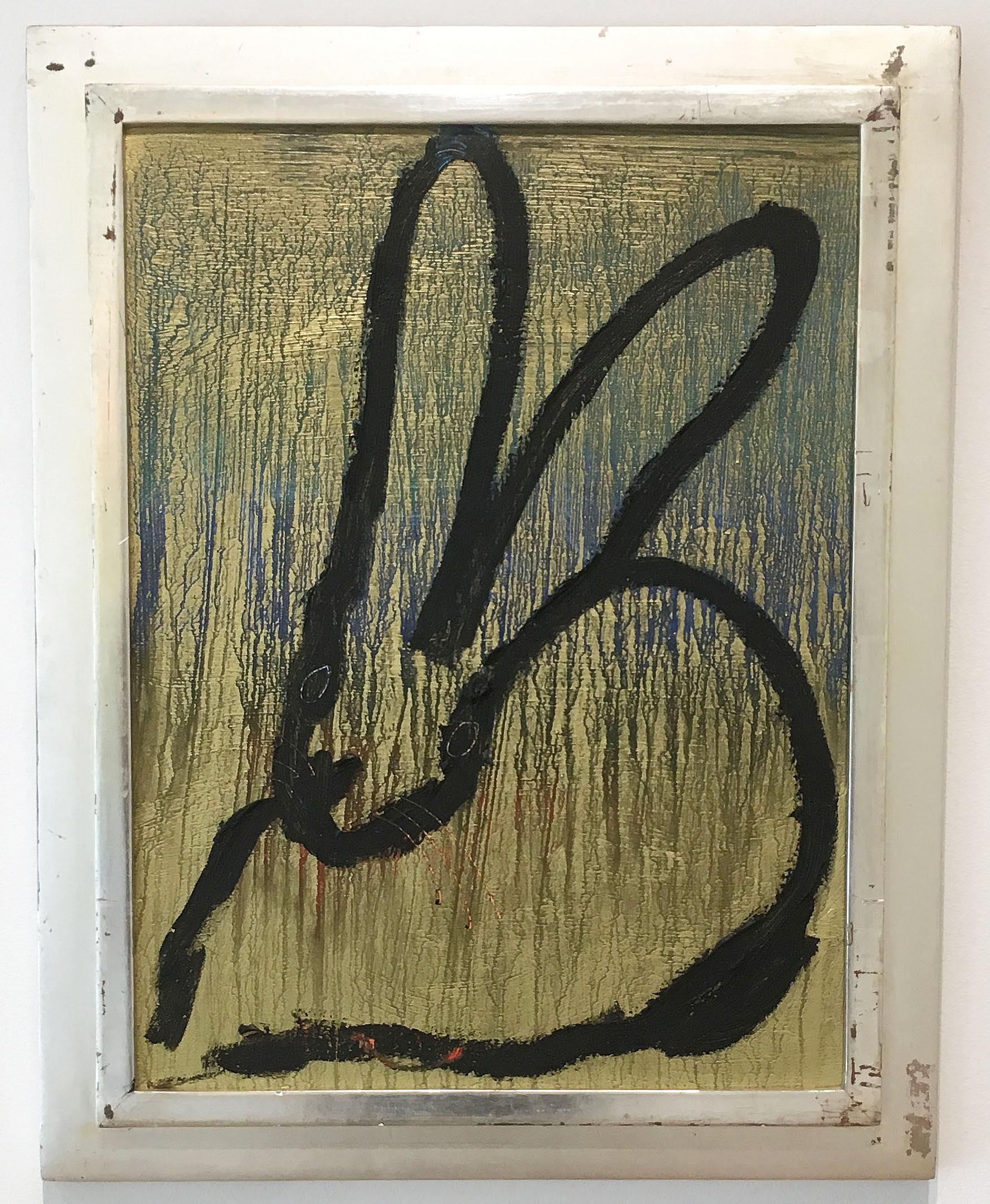 'Lone Ranger' 2017 by renowned New York City artist, Hunt Slonem. Oil and resin on wood, 21 x 16 in. / Frame: 24.75 x 19.5 in. This painting features a charming portrait of a bunny. The bunny is outlined in black and blue on a gold painted