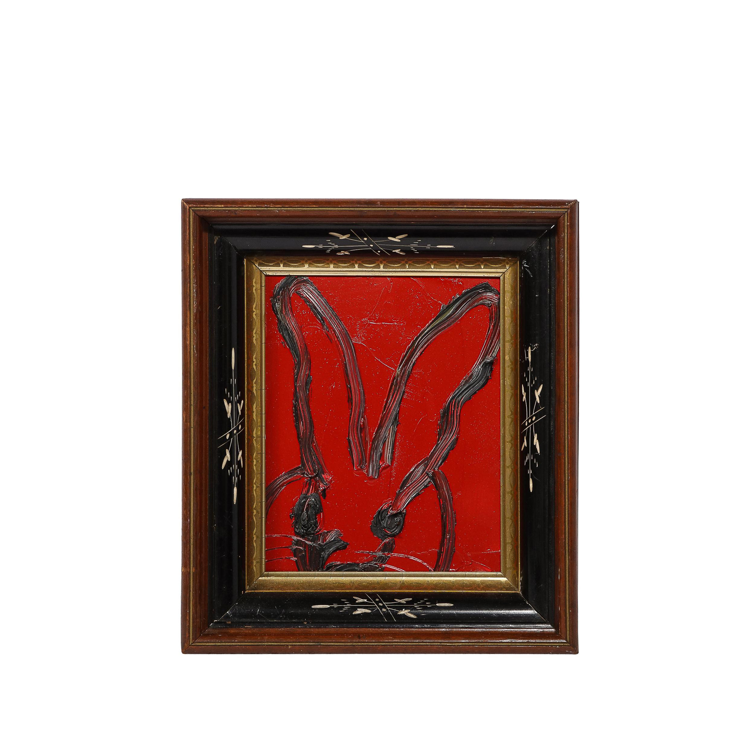 This sophisticated modern acrylic painting was realized by the esteemed contemporary painter, Hunt Slonem in 2018. It presents a stylized bunny rabbit, rendered with loose and expressive brush strokes in grisaille paint in profile against a ruby red