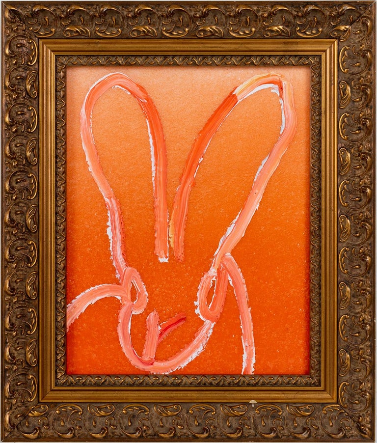 'Untitled' by Hunt Slonem, 2021. Oil and acrylic with diamond dust on wood, 10 x 8 in. Framed size is 14 x 12 in. This painting features Slonem's signature bunny outlined in a mixture of orange and white on a gradient orange background infused with