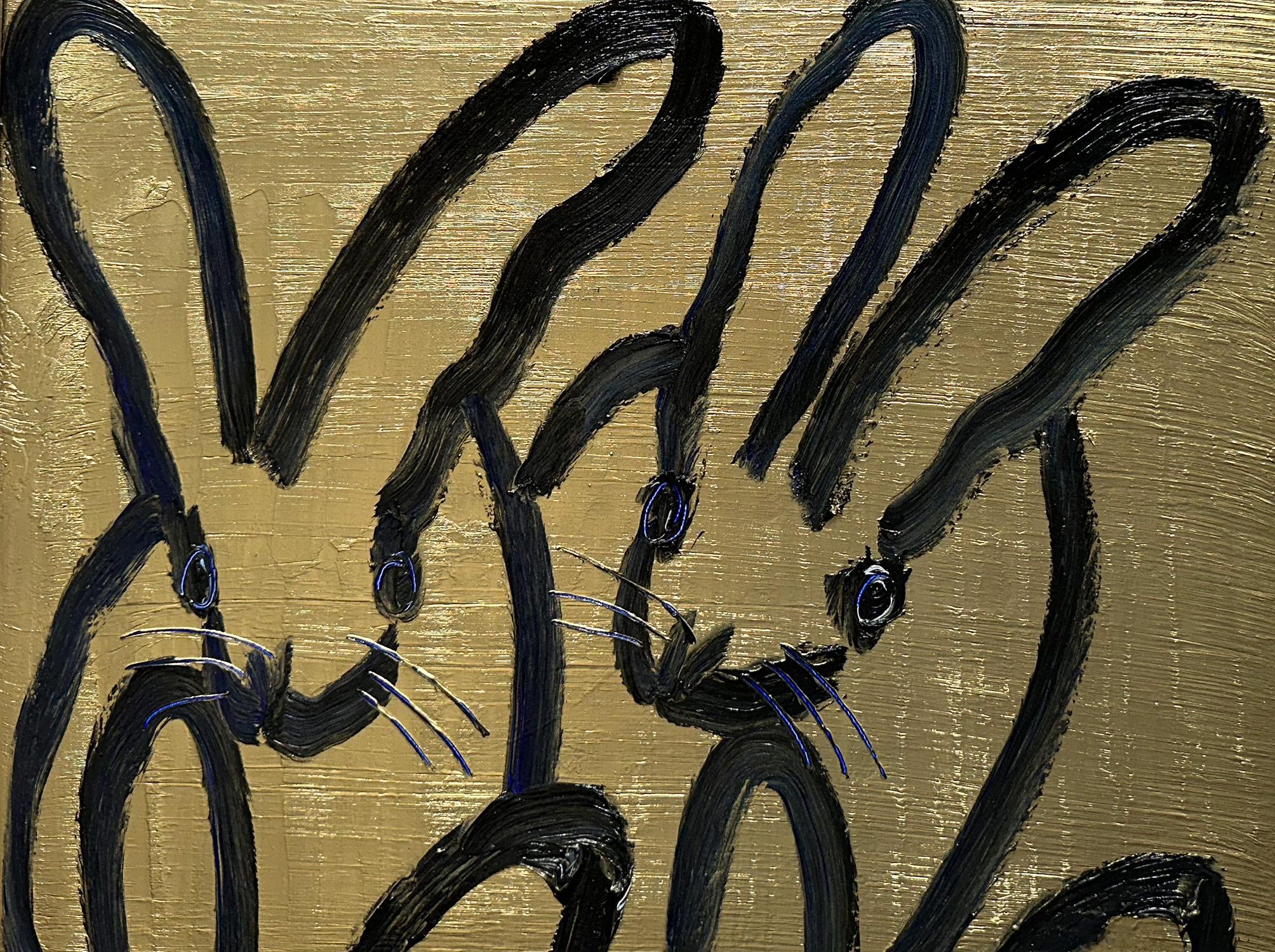 A wonderful composition of one of Slonem's most iconic subjects, Bunnies. This piece depicts 4 gestural figures of Bunnies against a gold background with navy blue accents.  Inspired by nature and a genuine love for animals, Slonem's paintings