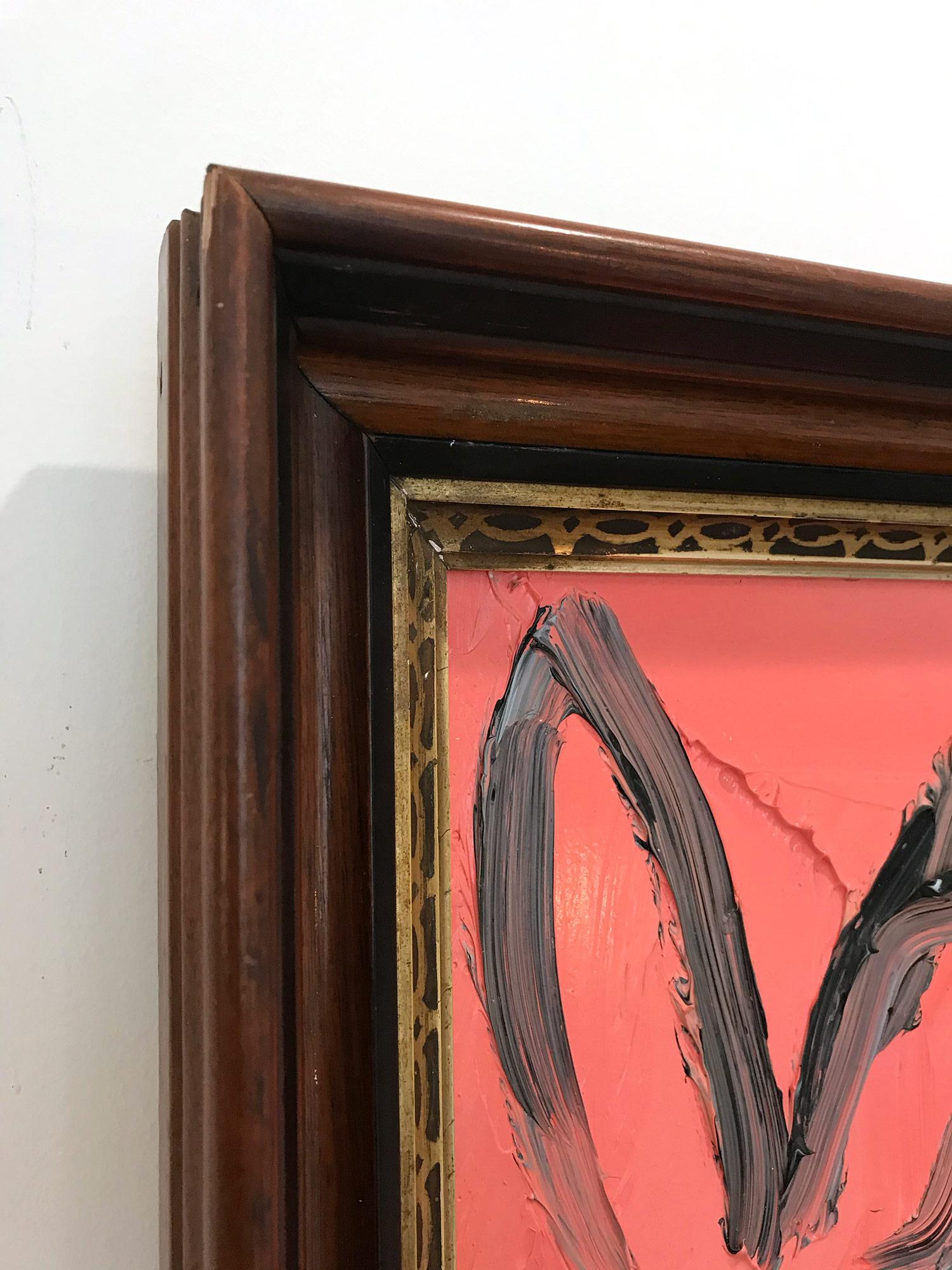 A wonderful composition of one of Slonem's most iconic subjects, Bunnies. This piece depicts a gestural figure of a black bunny peach background with thick use of paint. It is housed in a wonderful antique frame. Inspired by nature and a genuine