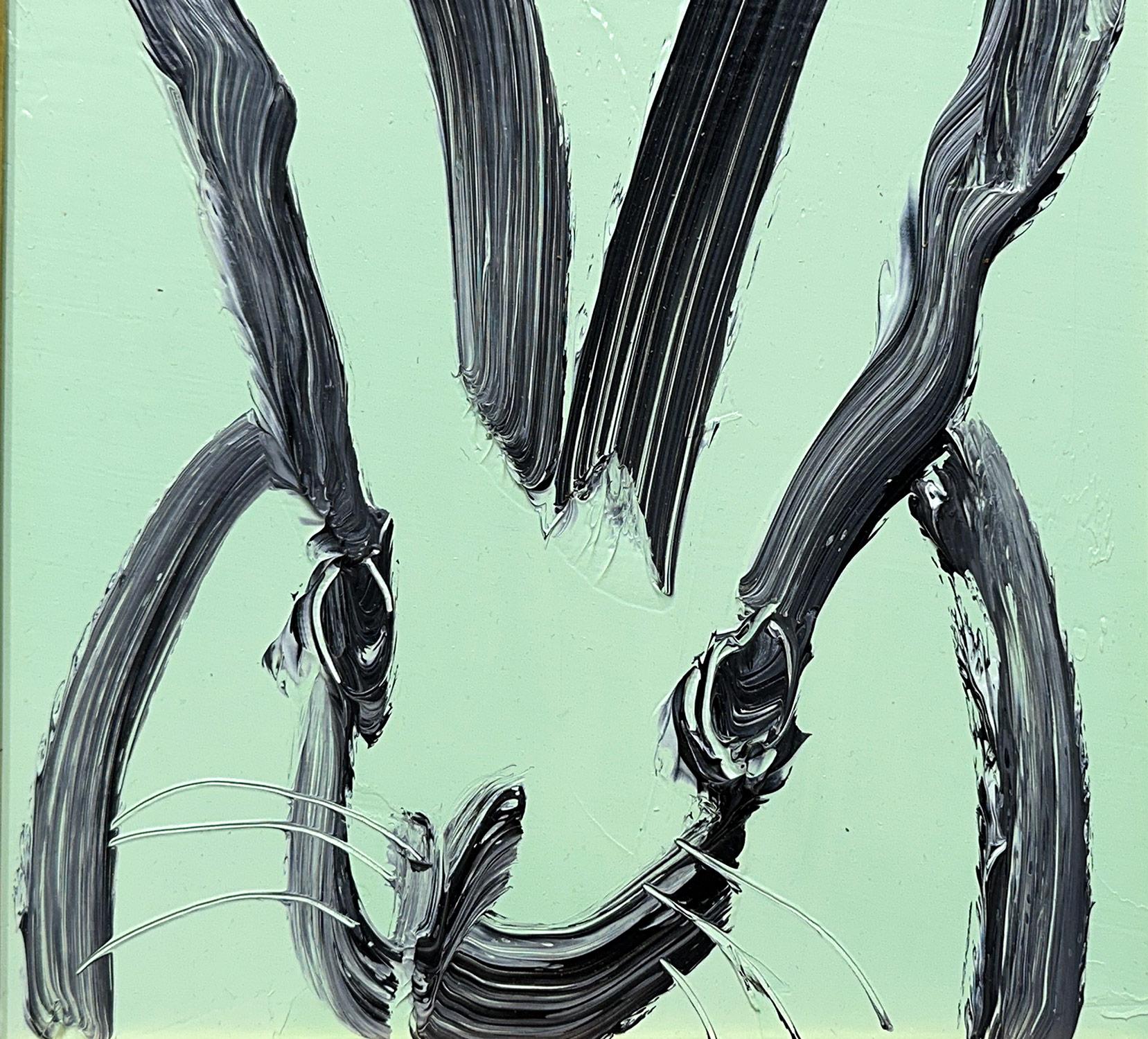 A wonderful composition of one of Slonem's most iconic subjects, Bunnies. This piece depicts a gestural figure of a black bunny on an Aqua Mist blue background with thick use of paint. It is housed in a wonderful gold tone wood frame. Inspired by
