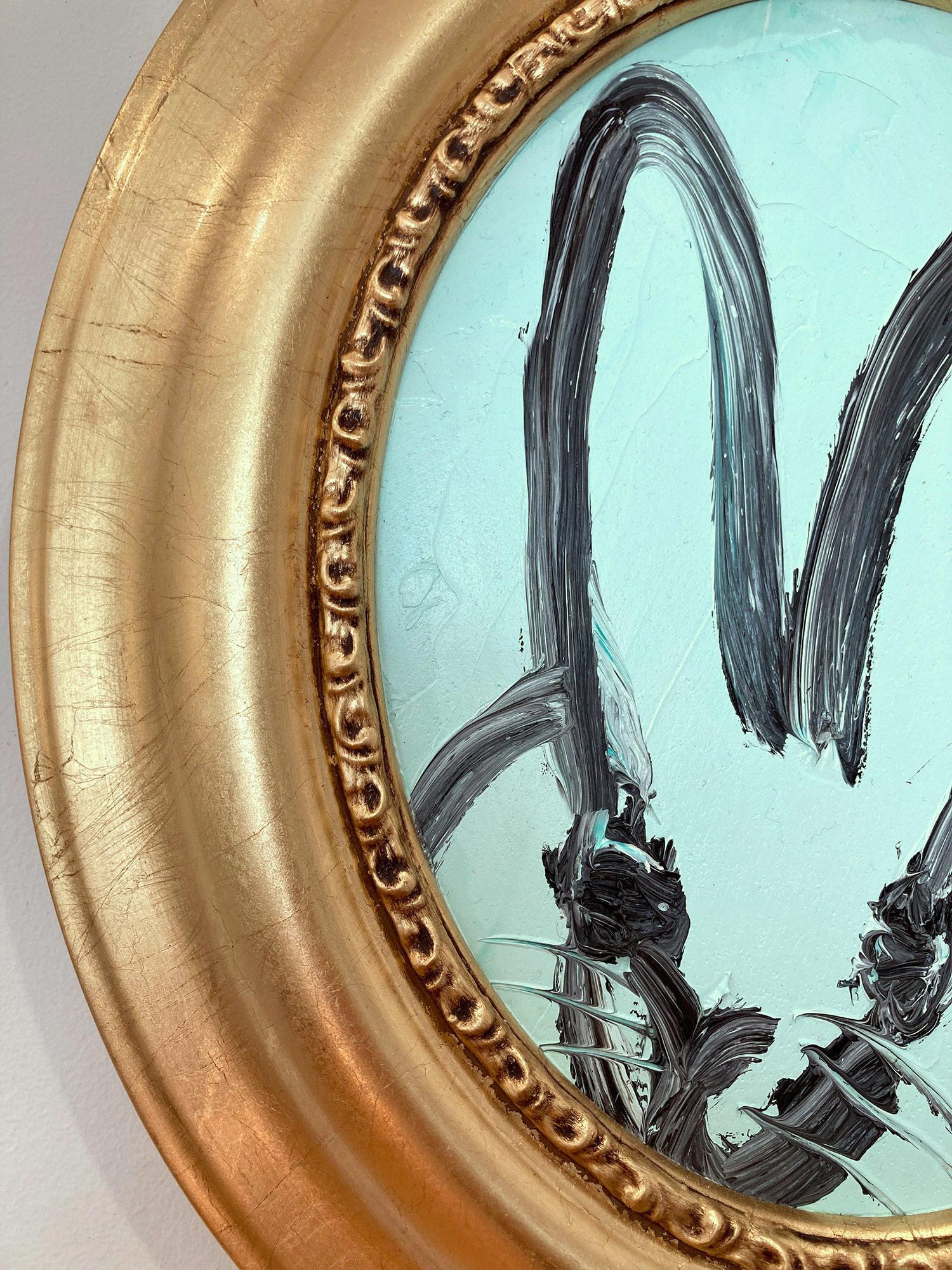 A wonderful composition of one of Slonem's most iconic subjects, Bunnies. This piece depicts a gestural figure of a black bunny on Powder Blue background with thick use of paint. It is housed in a wonderful antique style gold tone frame. Inspired by