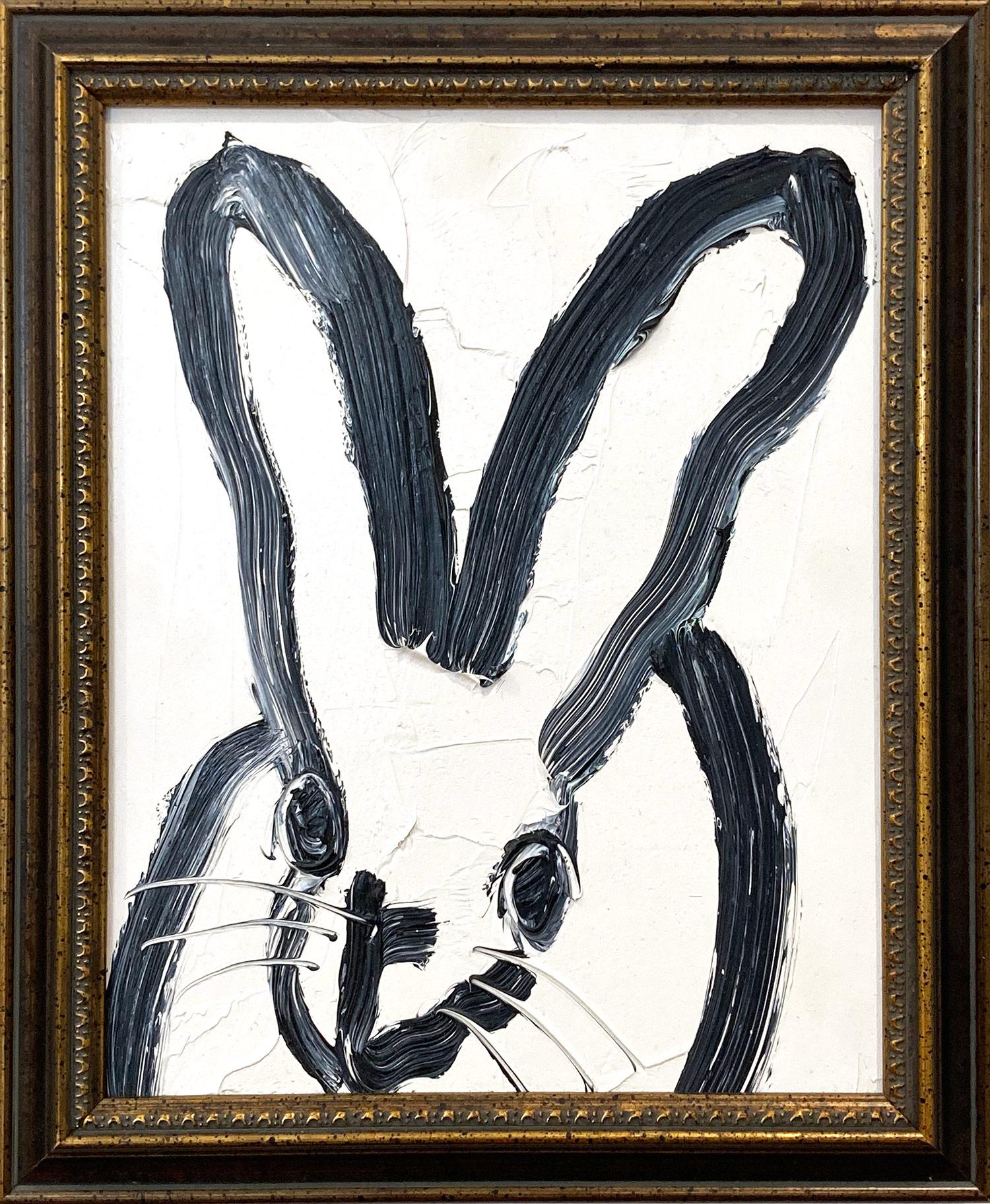 A wonderful composition of one of Slonem's most iconic subjects, Bunnies. This piece depicts a gestural figure of a black bunny on white background with thick use of paint. It is housed in a wonderful gold tone antique style frame. Inspired by