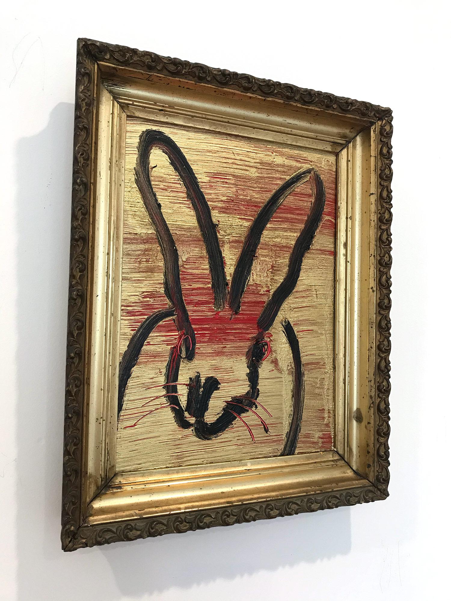 A wonderful composition of one of Slonem's most iconic subjects, Bunnies. This piece depicts a gestural figure of a black bunny on a gold background and red with thick use of oil paint. It is housed in a wonderful antique 19th Century frame.