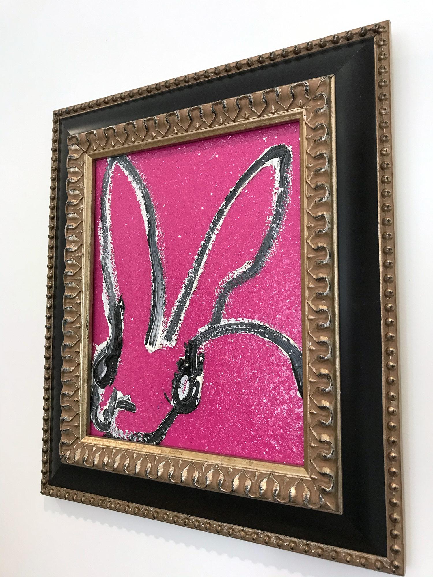 A wonderful composition of one of Slonem's most iconic subjects, Bunnies. This piece depicts a gestural figure of a black and white bunny on a pink background with thick use of paint and diamond dust. It is housed in a wonderful frame. Inspired by