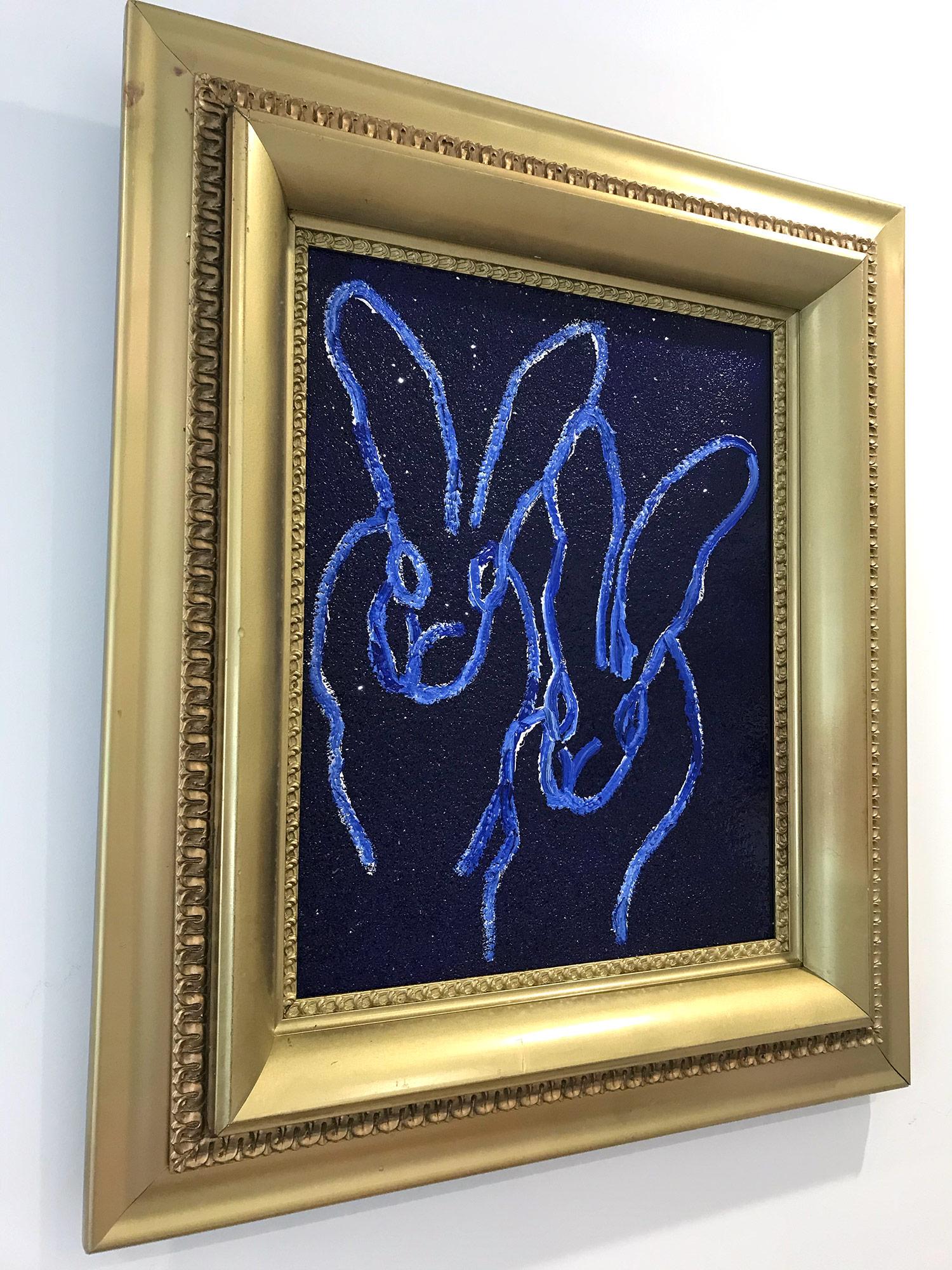 A wonderful composition of one of Slonem's most iconic subjects, Bunnies. This piece depicts a gestural figure of 2 white bunnies on an ultramarine blue background with thick use of paint and diamond dust. It is housed in a wonderful antique 19th