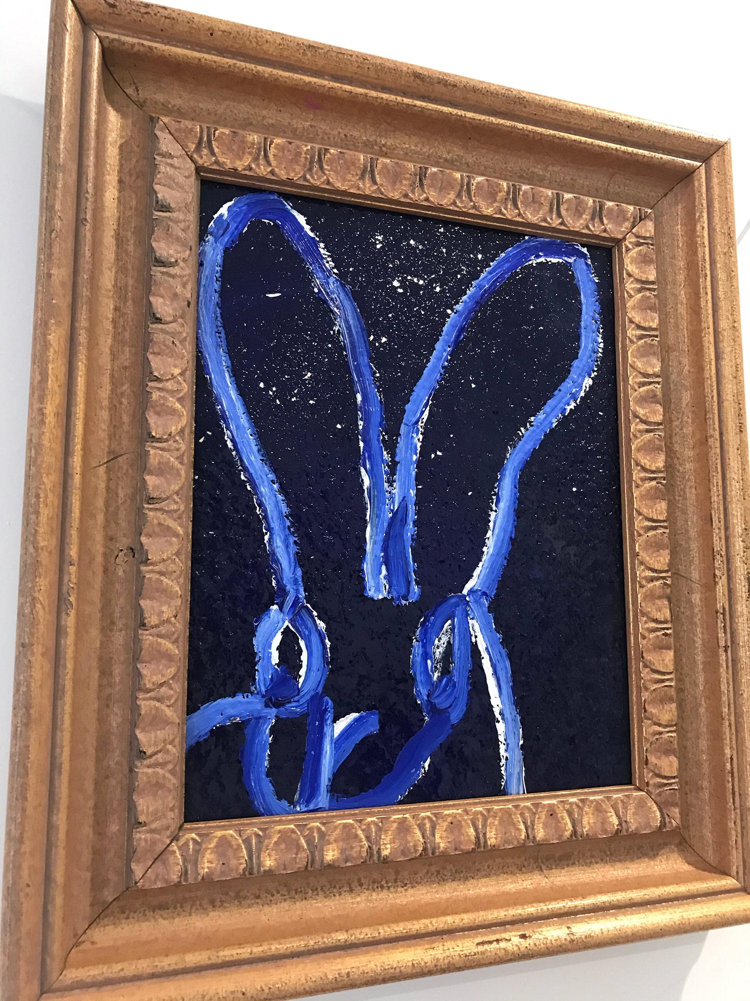 A wonderful composition of one of Slonem's most iconic subjects, Bunnies. This piece depicts a gestural figure of a white bunny on an ultramarine blue background with thick use of paint and diamond dust. It is housed in a wonderful antique frame.