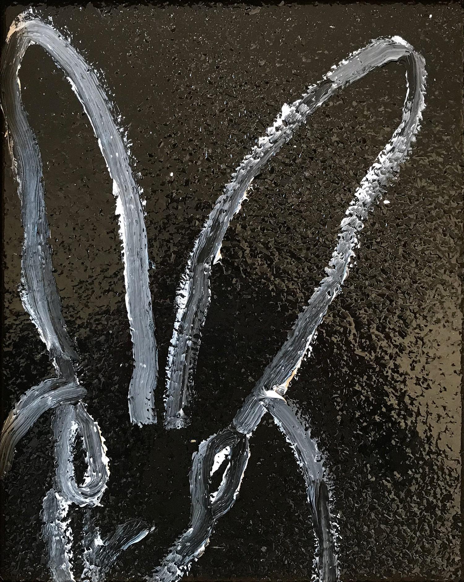 A wonderful composition of one of Slonem's most iconic subjects, Bunnies. This piece depicts a gestural figure of a white bunny on a black background with thick white paint and then encases the piece in diamond dust, which adds another level of