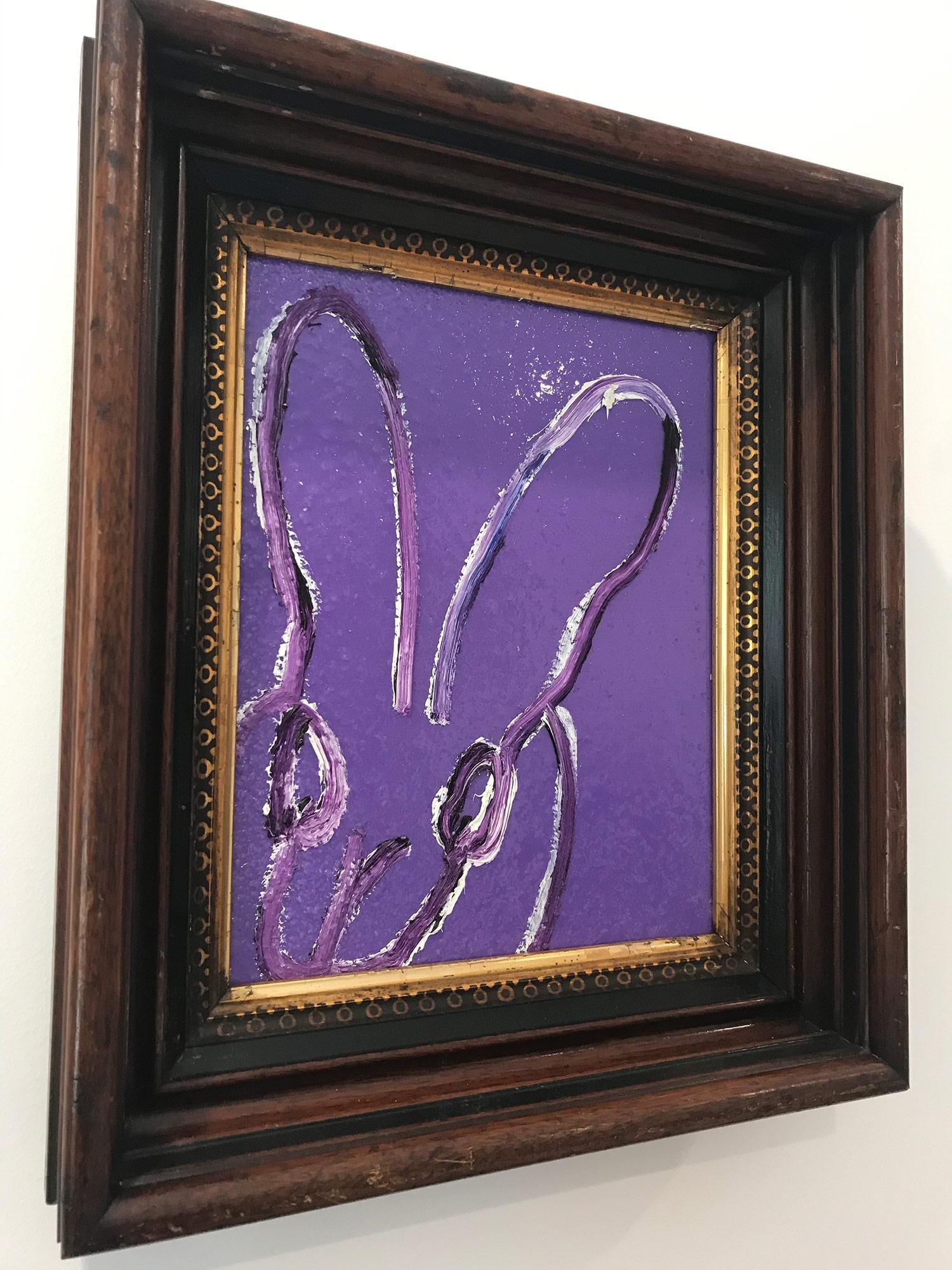 A wonderful composition of one of Slonem's most iconic subjects, Bunnies. This piece depicts a gestural figure of a white bunny on a Purple background with thick use of paint and diamond dust. It is housed in a wonderful antique frame. Inspired by