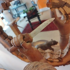 Hunter and tiger wooden sculpture