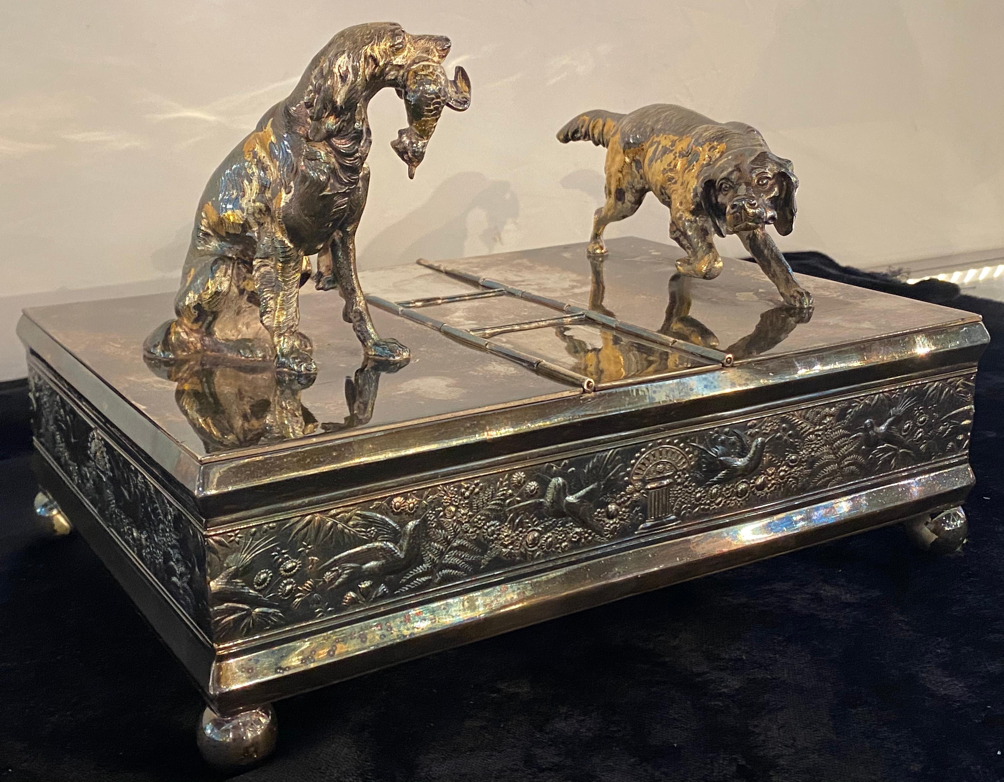 Hunting dog humidor for Cigars. Part of our extensive Cigar collection. By Meriden & Company (American (Connecticut), founded 1808). A quadruple silver plated humidor of rectangular form having two figural hunting dogs on lids as handles. With two