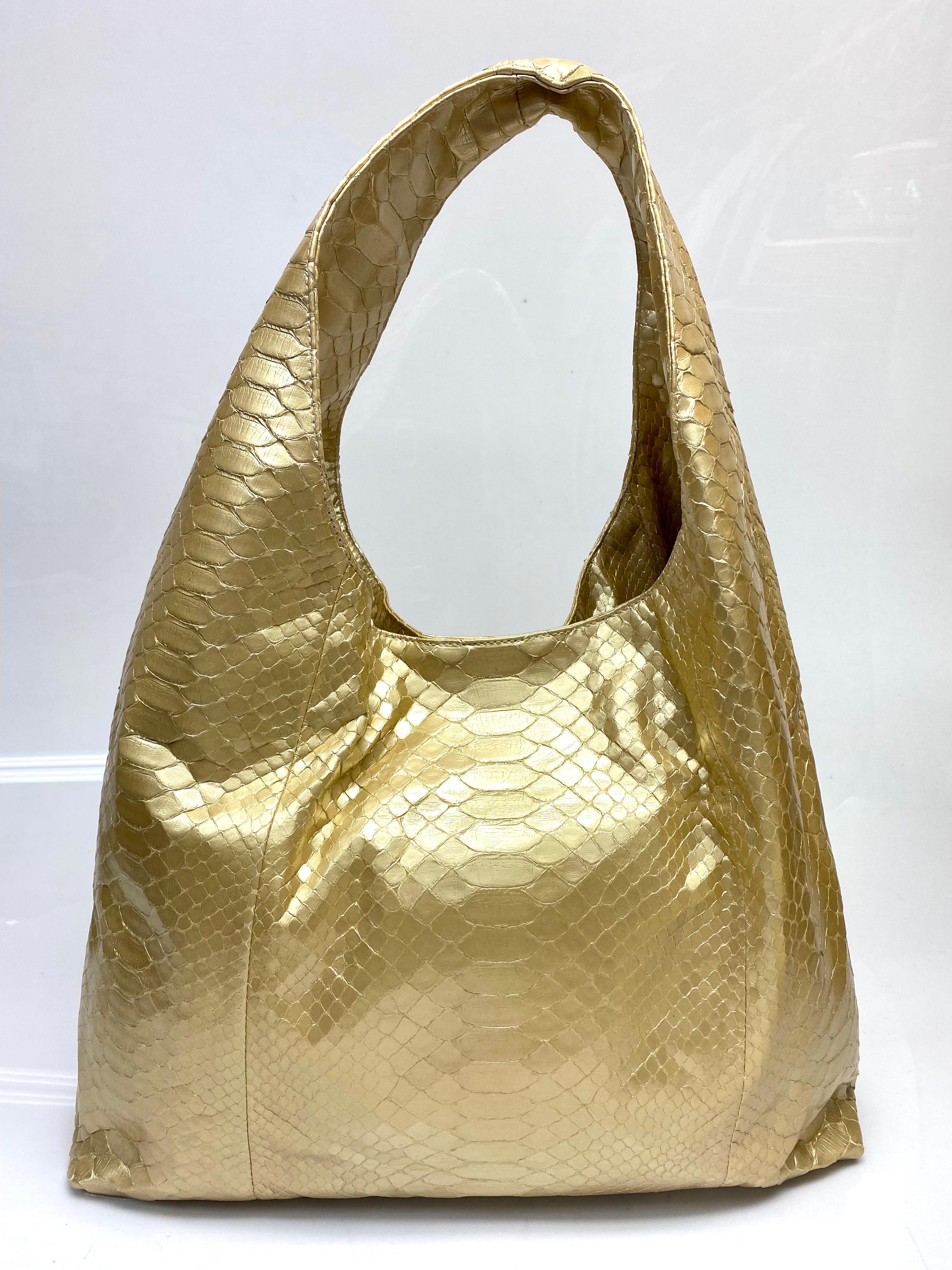 Beautiful gold Hunting Season handbag in python, perfect for every fashionista on the go. Bag is in a large size to fit all of your necessities with an interior open flap pocket and zipped pocket. Bag is in good condition with some lift in python as