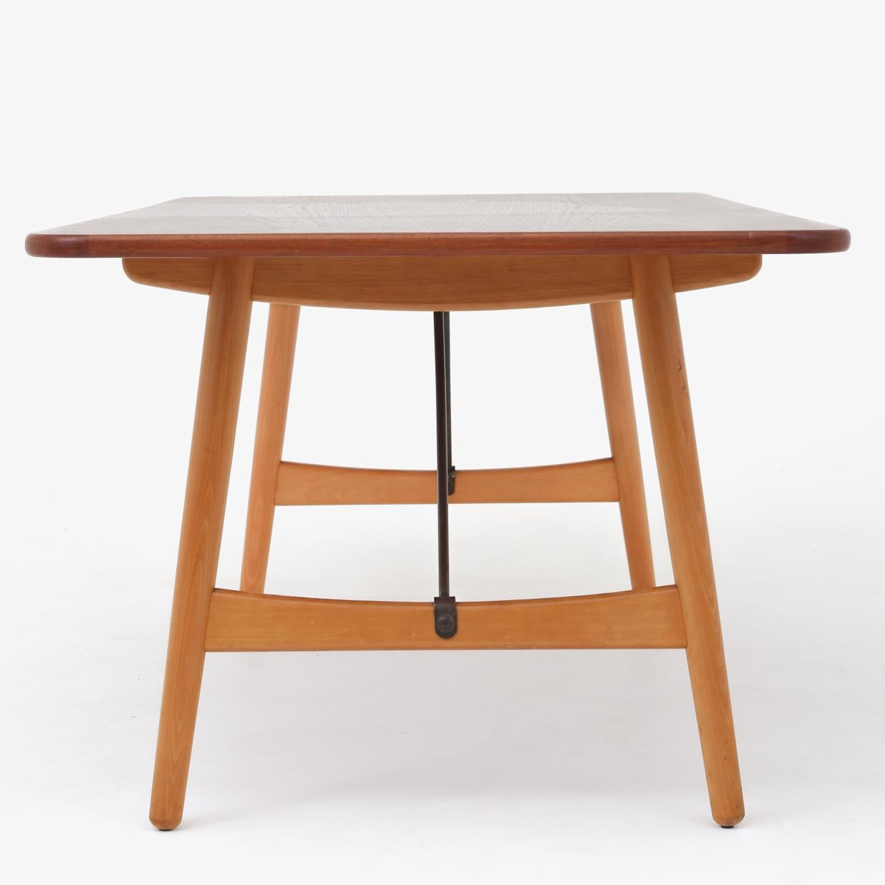 'Hunting Table' dining table with patinated beech frame, teak top with rounded corners and brass supports. Designed in 1950. Maker Søborg Møbler