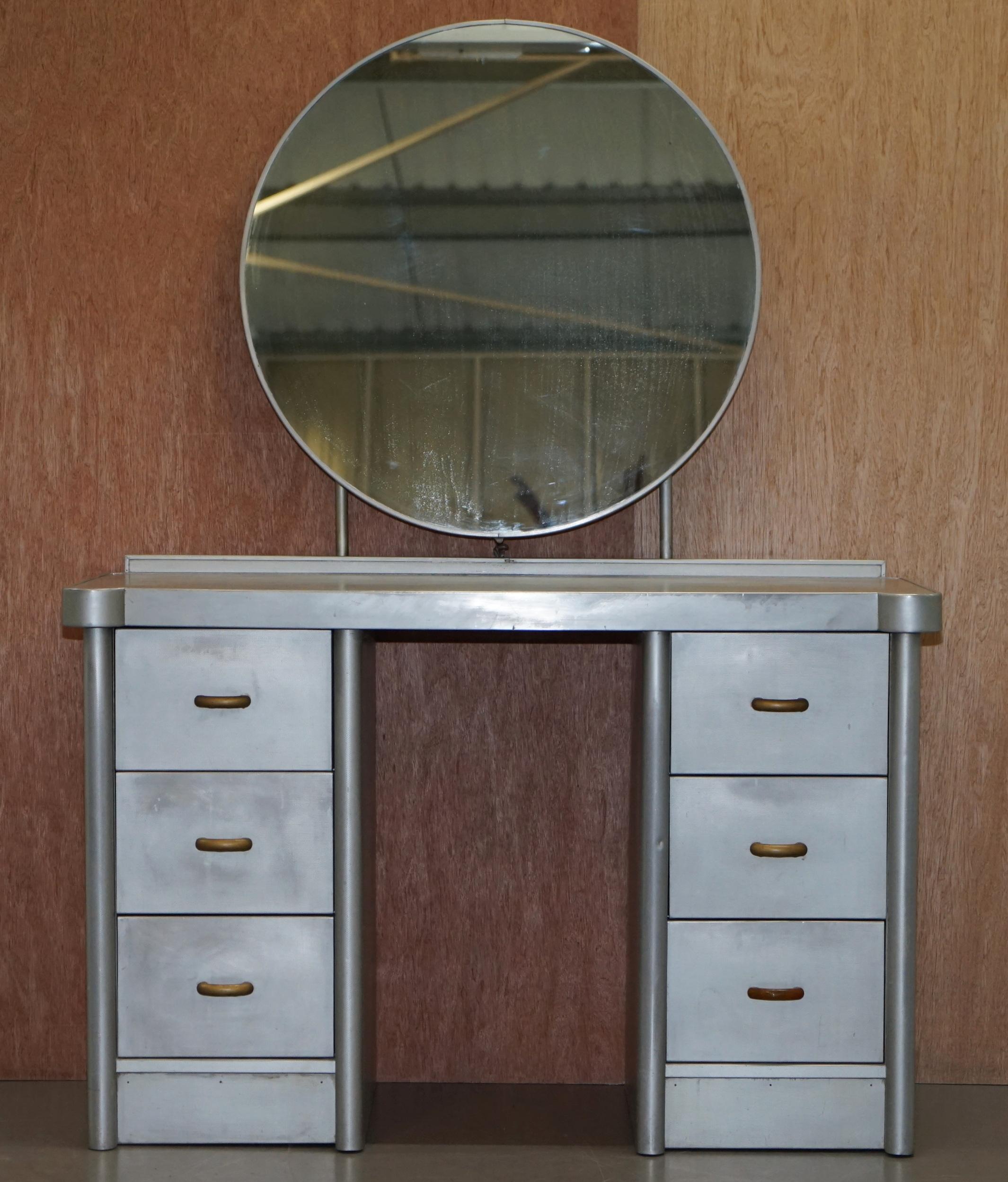 We are delighted to this stunning original Huntington Aviation Art Deco aluminum dressing table and mirror

This piece is part of a suite, I have in total a bedside table, a tall boy cupboard, the head and foot bed boards, a large double wardrobe
