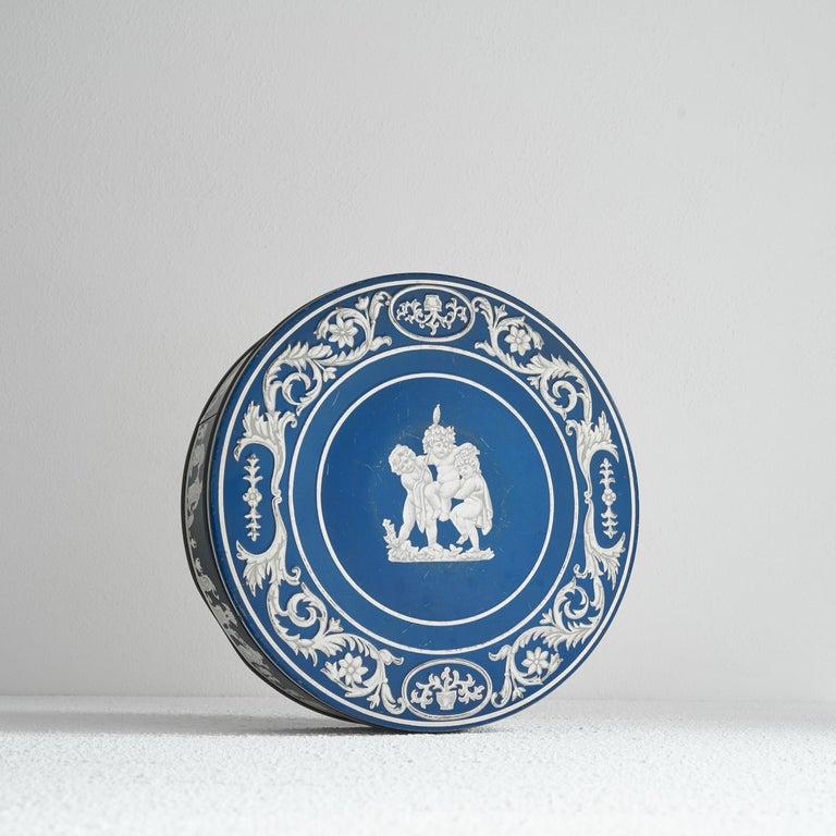 HuntleyÂ Boorne & Stevens Mid Century â€˜Wedgwood Jasperwareâ€™ Biscuit Tin, England, mid 20th century.    This is a very decorative biscuit tin by HuntleyÂ Boorne & Stevens, one of the premier makers of tins in England in the previous decades. This
