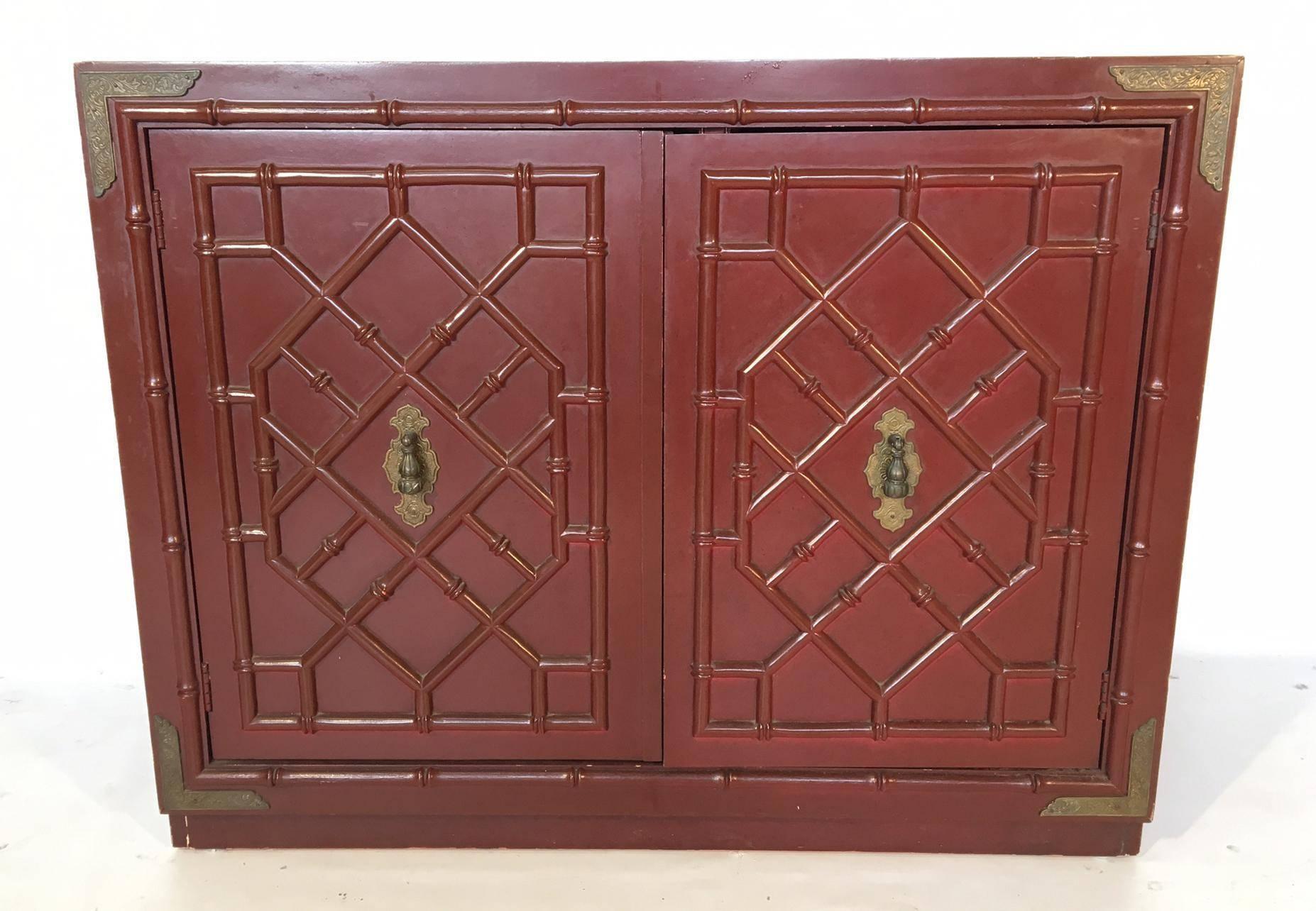Faux bamboo cabinet in deep oxblood red featuring brass hardware and detailing. Doors reveal storage space with large drawer. Good vintage condition with minor abrasions consistent with age.
As always, all reasonable offers will be considered.