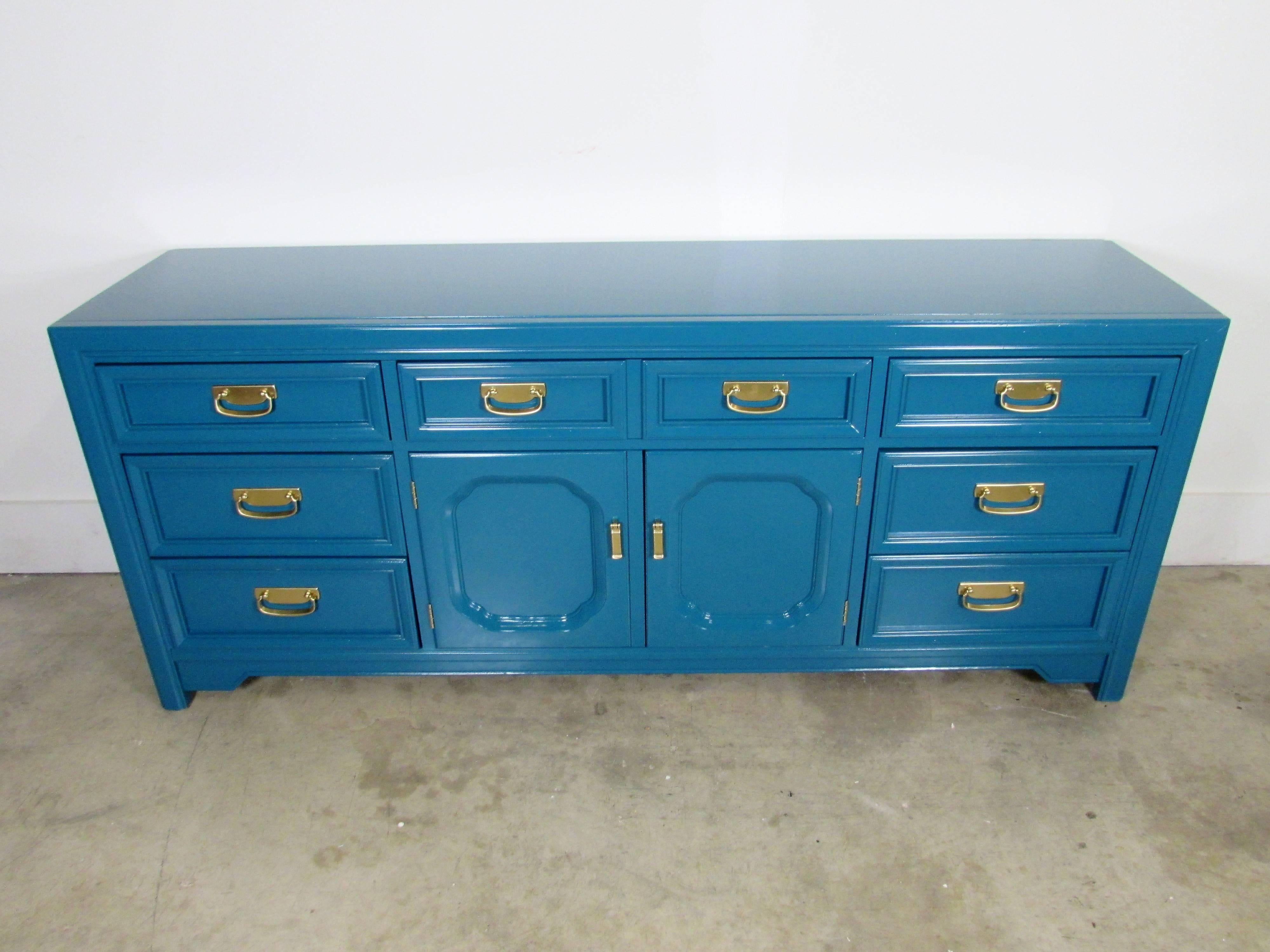 Huntley by Thomasville Credenza with nine dovetail drawers, lacquered in-house in Benjamin Moore Jade Garden and the two swinging doors open to two of the drawers. Original brass hardware in our custom gold.