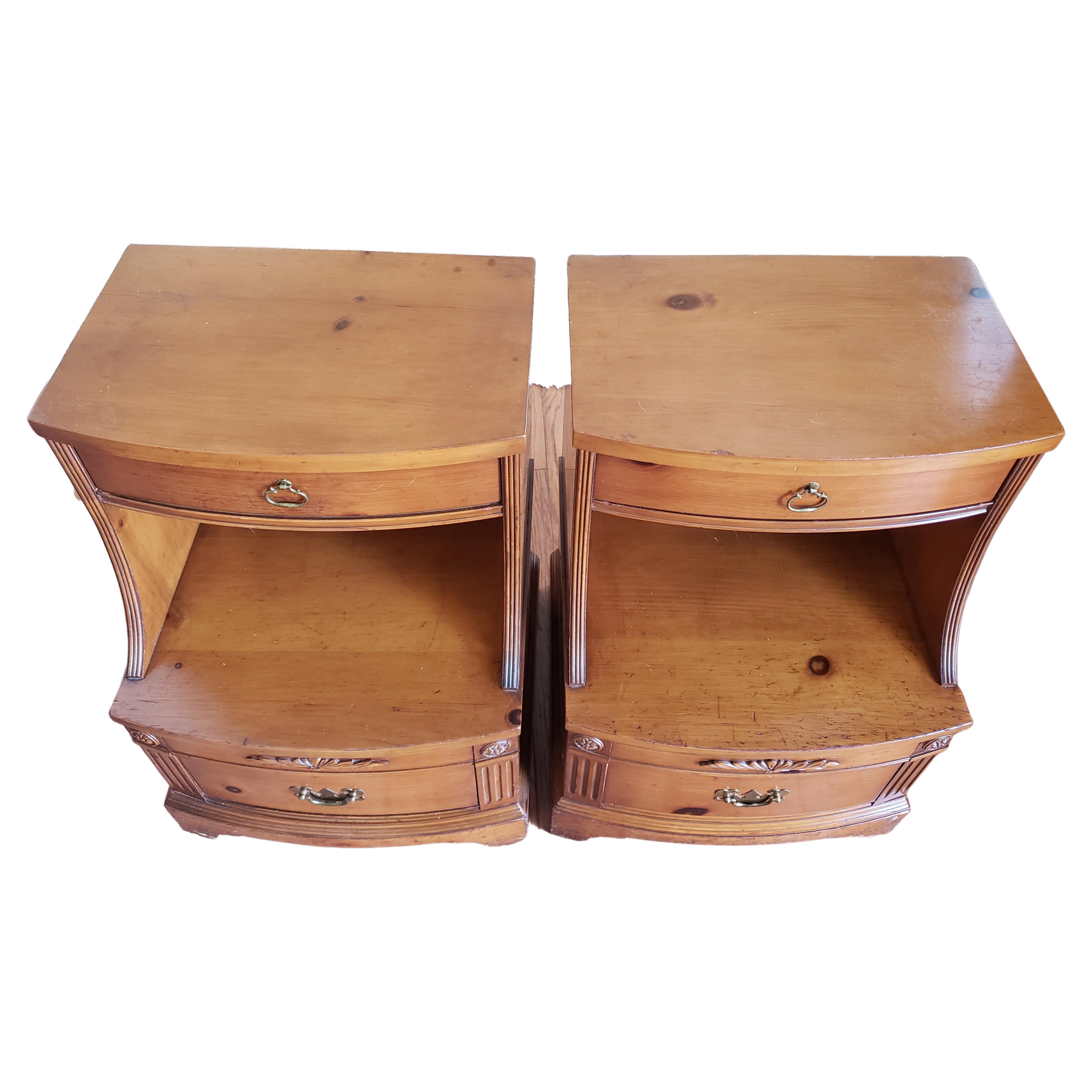 Pair of beautiful two drawer, two tier nightstands, made by Huntley Furniture in the 1940s. Good vintage condition featuring a bottom and a top drawer, all dovetailed. Nice front carving. Good vintage condition with wear appropriate with age and